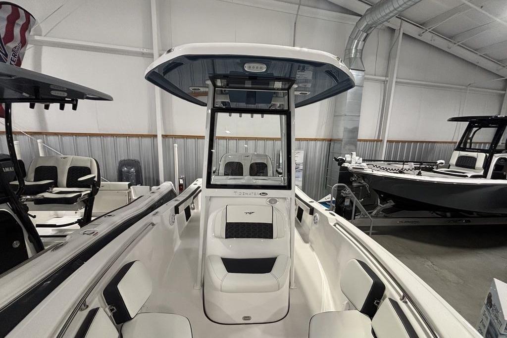 2026 Tidewater 198 CC Adventure boat interior in showroom, featuring seating and console.