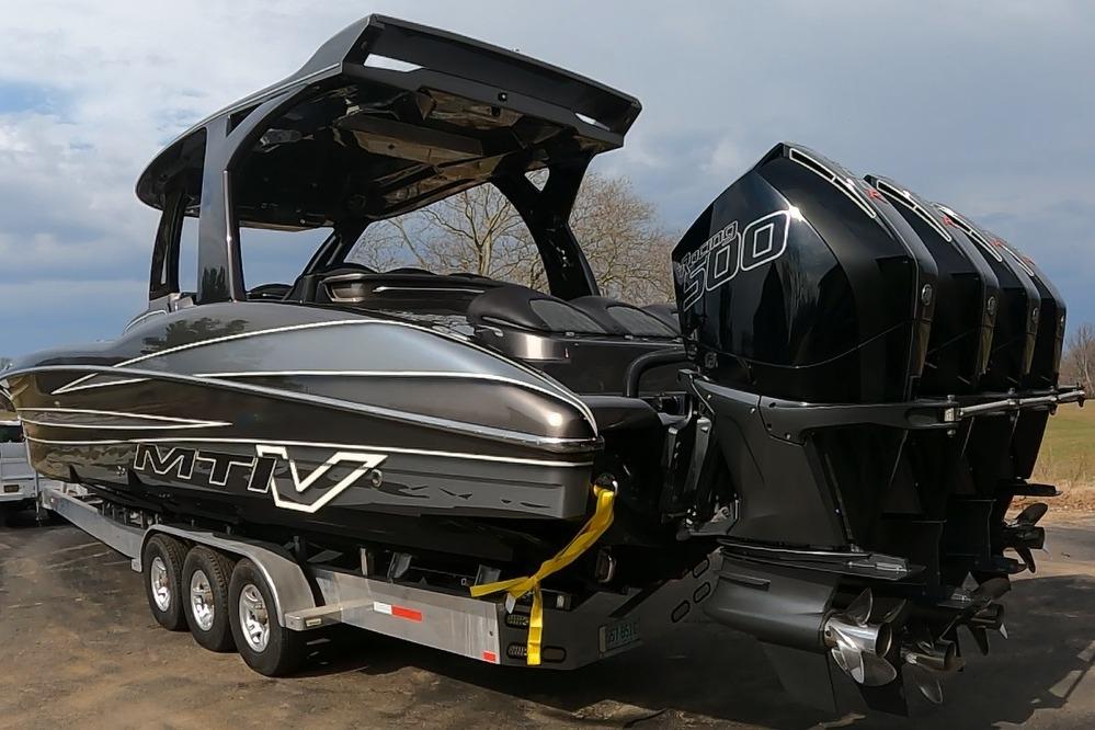 2018 MTI V42 boat with triple outboard engines on a trailer.