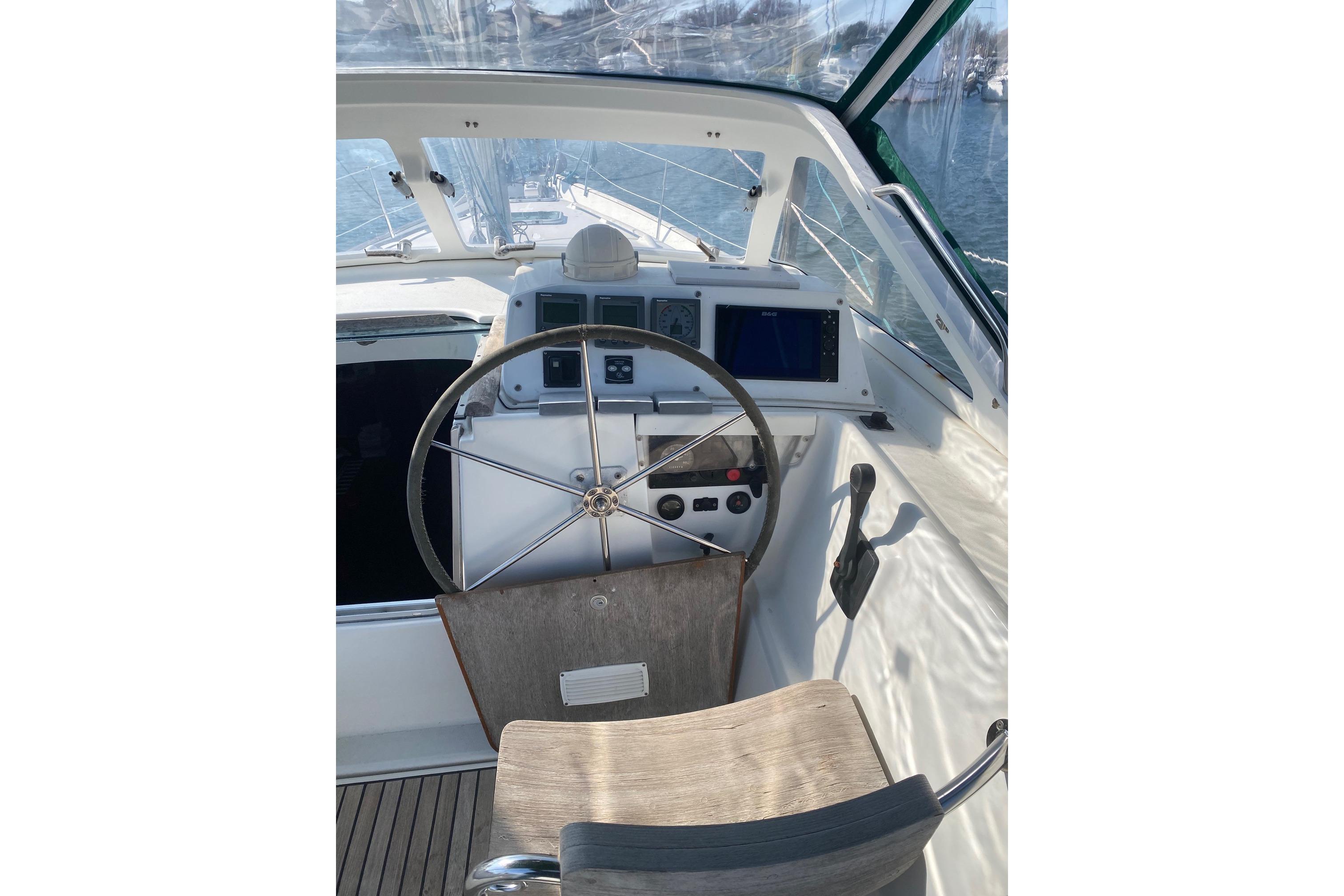 Cockpit of 2005 Beneteau Oceanis 42CC sailboat with steering wheel and navigation instruments.