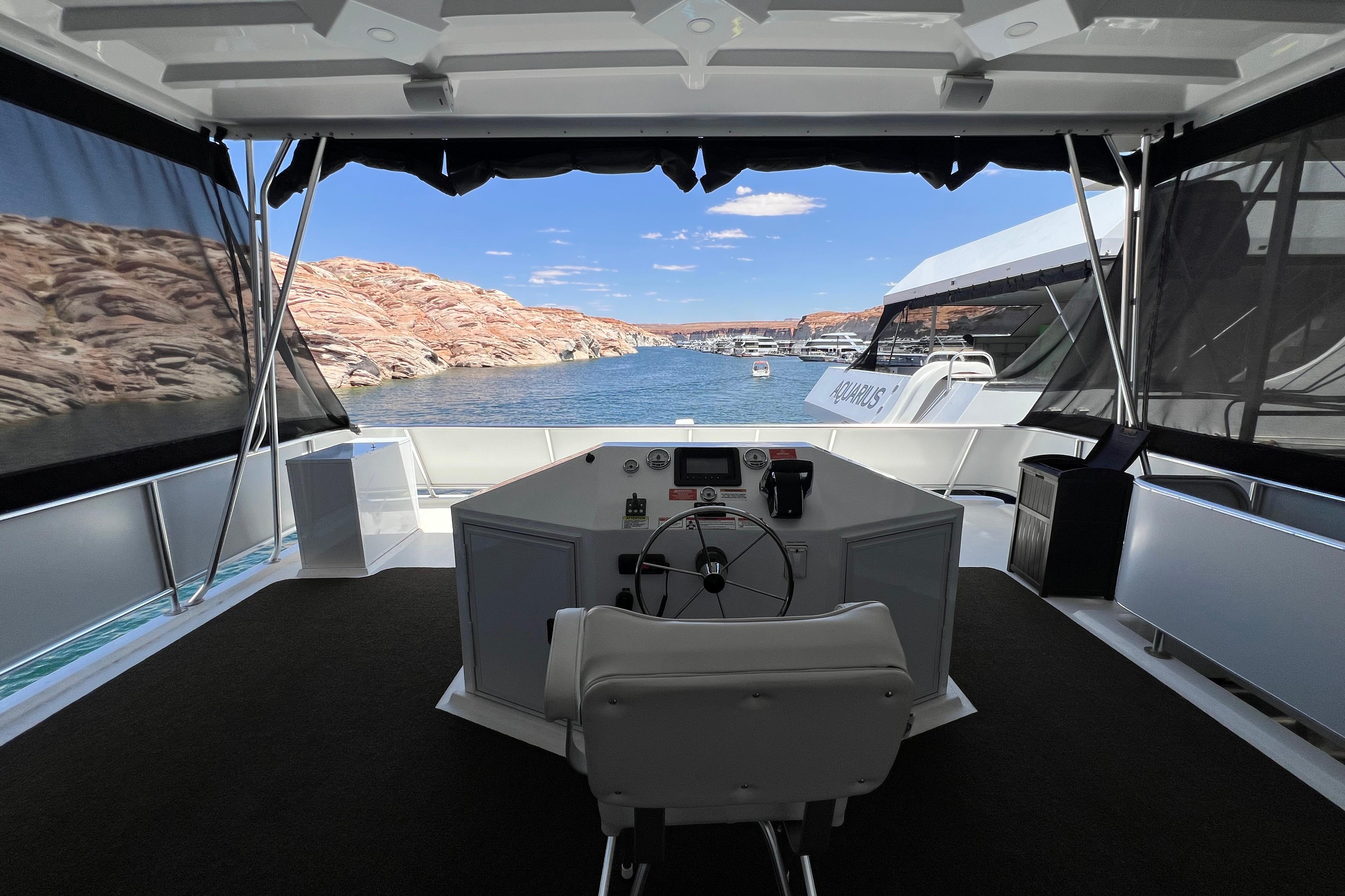 Pilot area of 2025 Sumerset Excellence Multiple Shares houseboat with scenic water view.