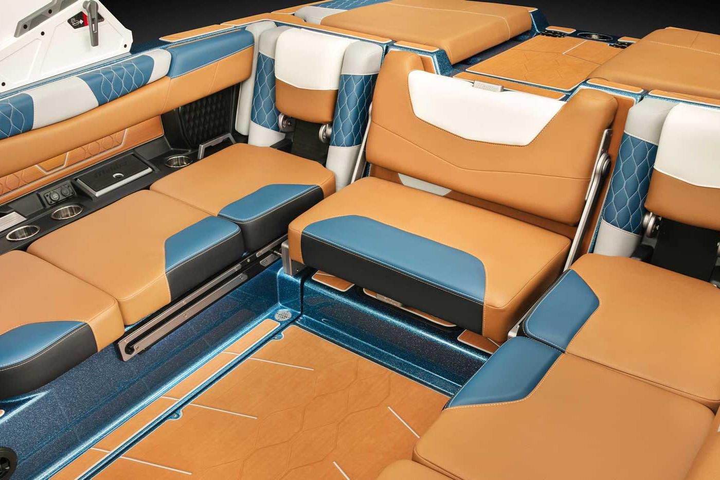Manufacturer Provided Image: 2022 Malibu M220 boat interior with tan, blue, and white leather seats.