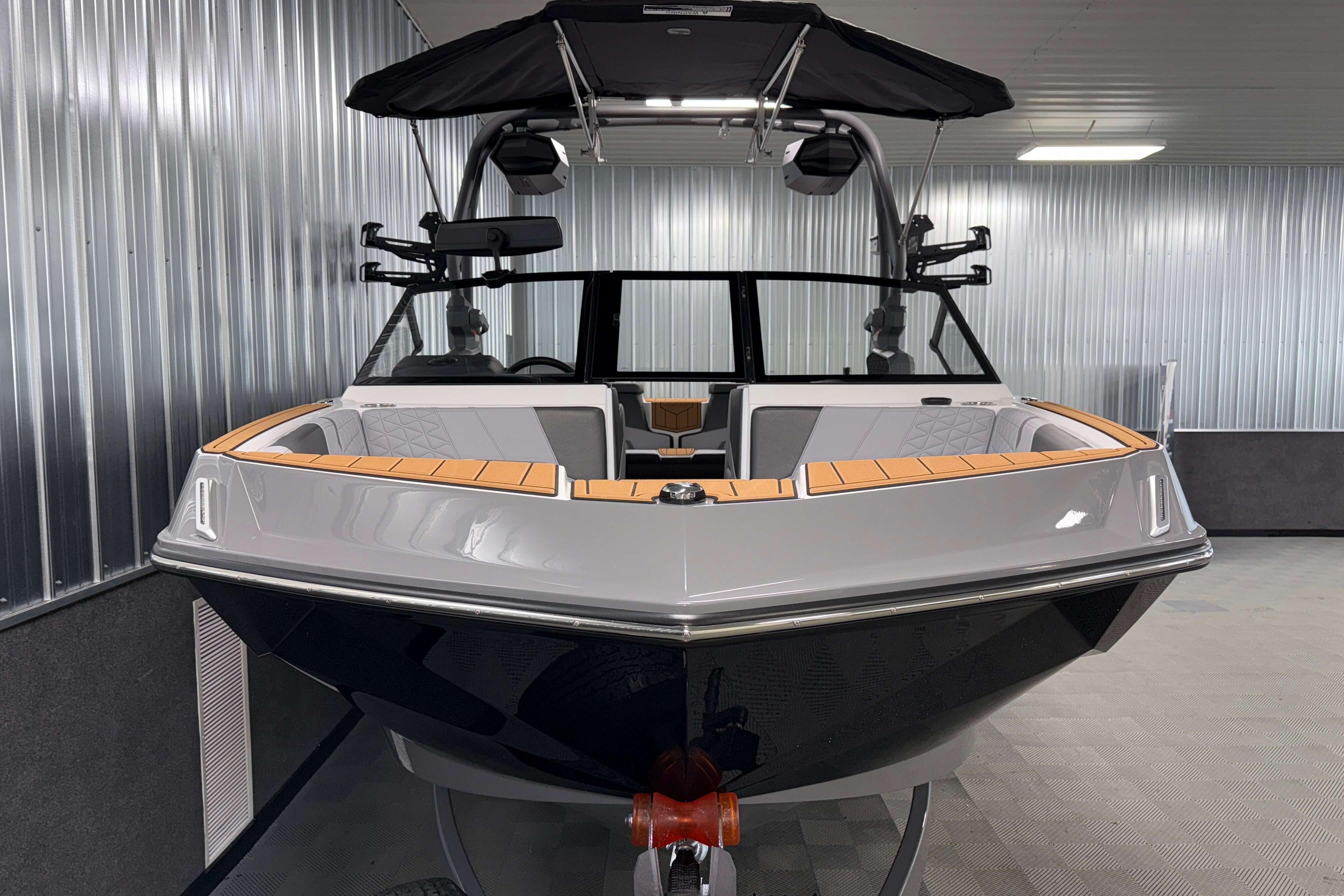 2026 Nautique Super Air Nautique GS22 boat in a modern indoor showroom.