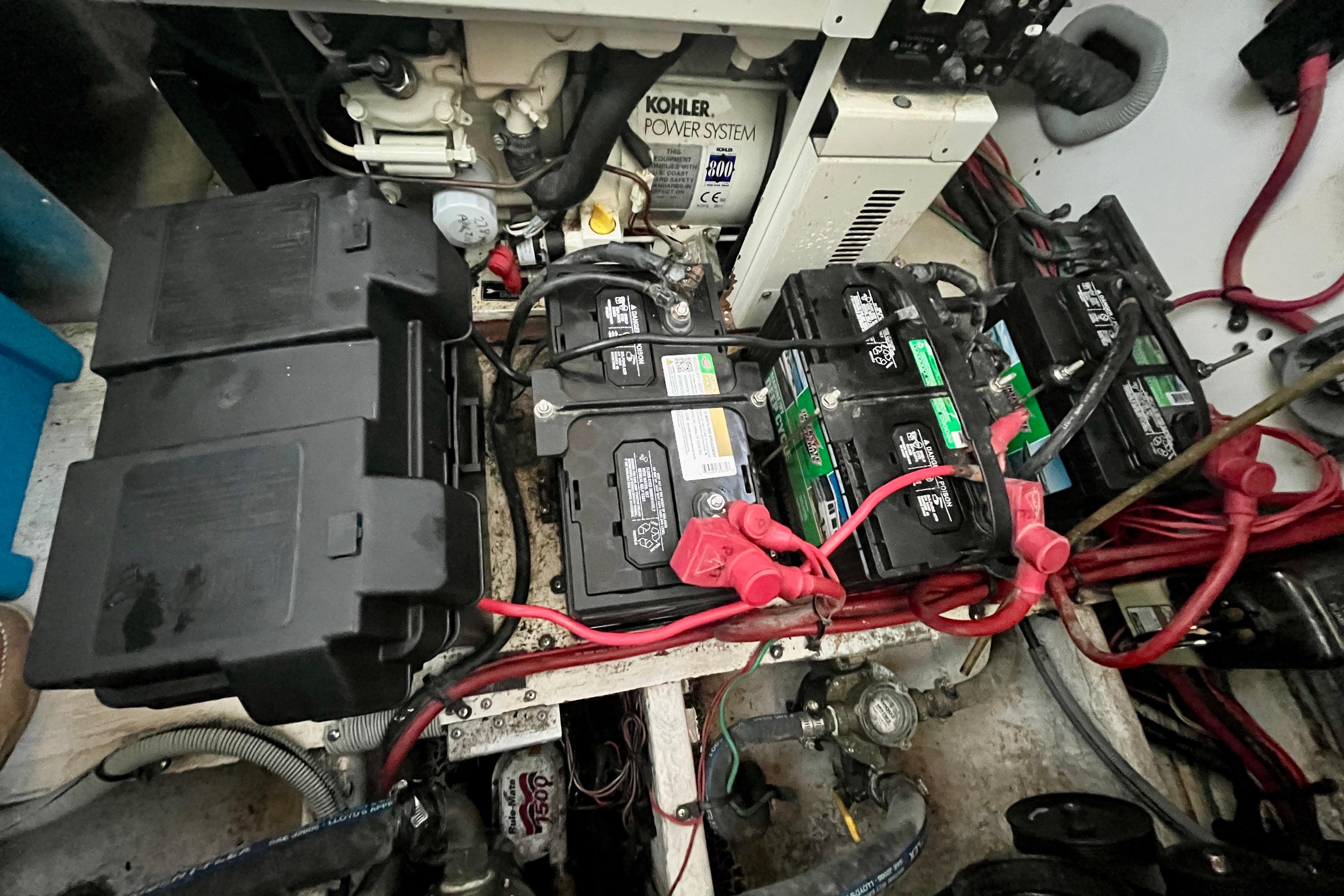 Engine compartment of 2001 Cruisers Yachts 3470 Express with batteries and Kohler power system.