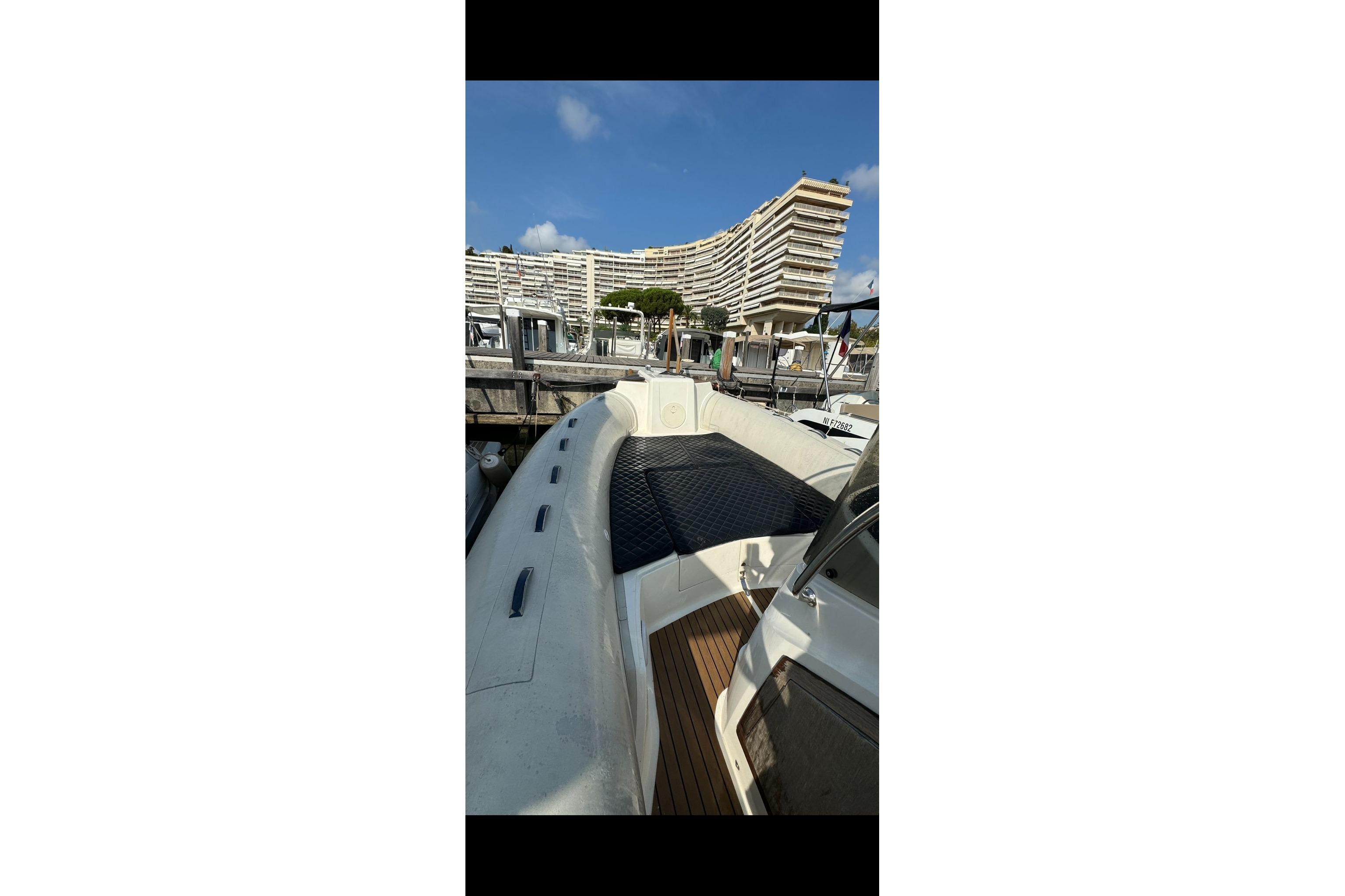2020 Capelli Tempest 775 boat docked at marina with modern architecture in background.