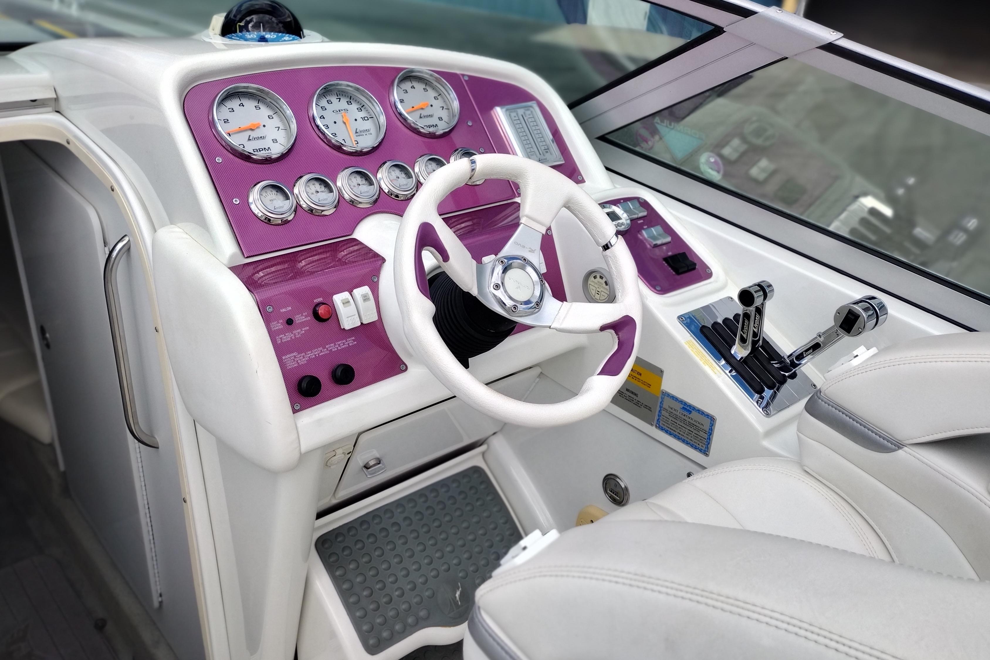 2006 Formula 353 FASTech boat cockpit with purple dashboard and white steering wheel.