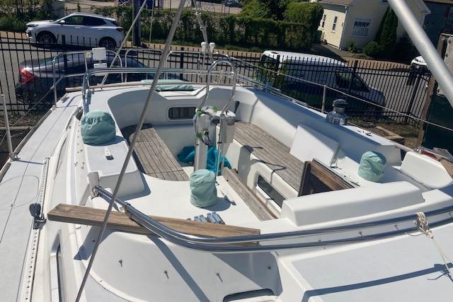 1988 Westerly Corsair 36 sailboat cockpit with wooden deck and covered equipment.