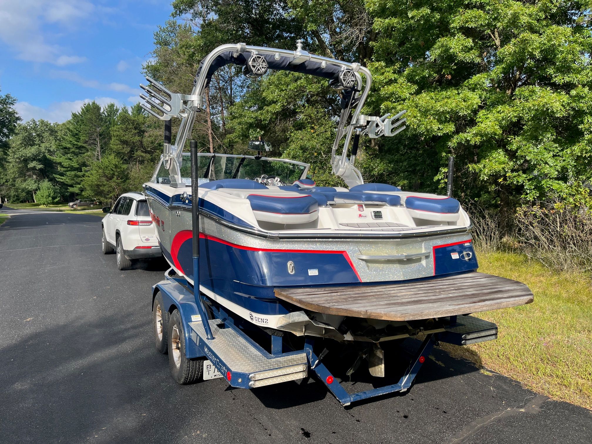 2015 MasterCraft X20 boat on trailer, parked outdoors.