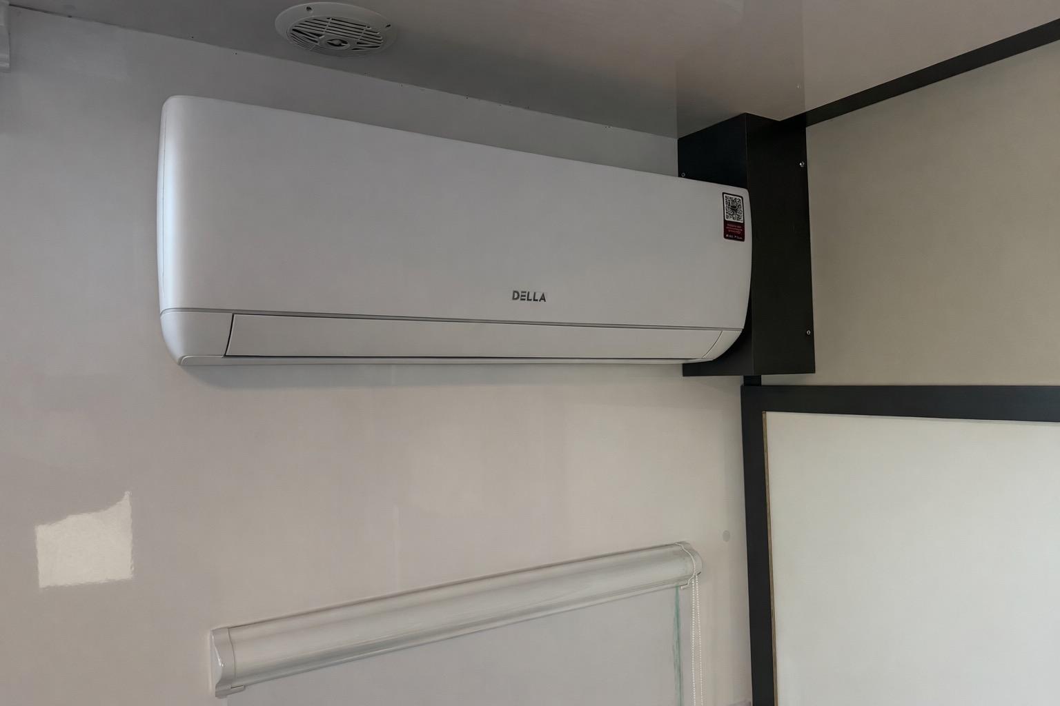 Wall-mounted air conditioning unit inside Navisyo NV.08, 2022 model, with sleek design.
