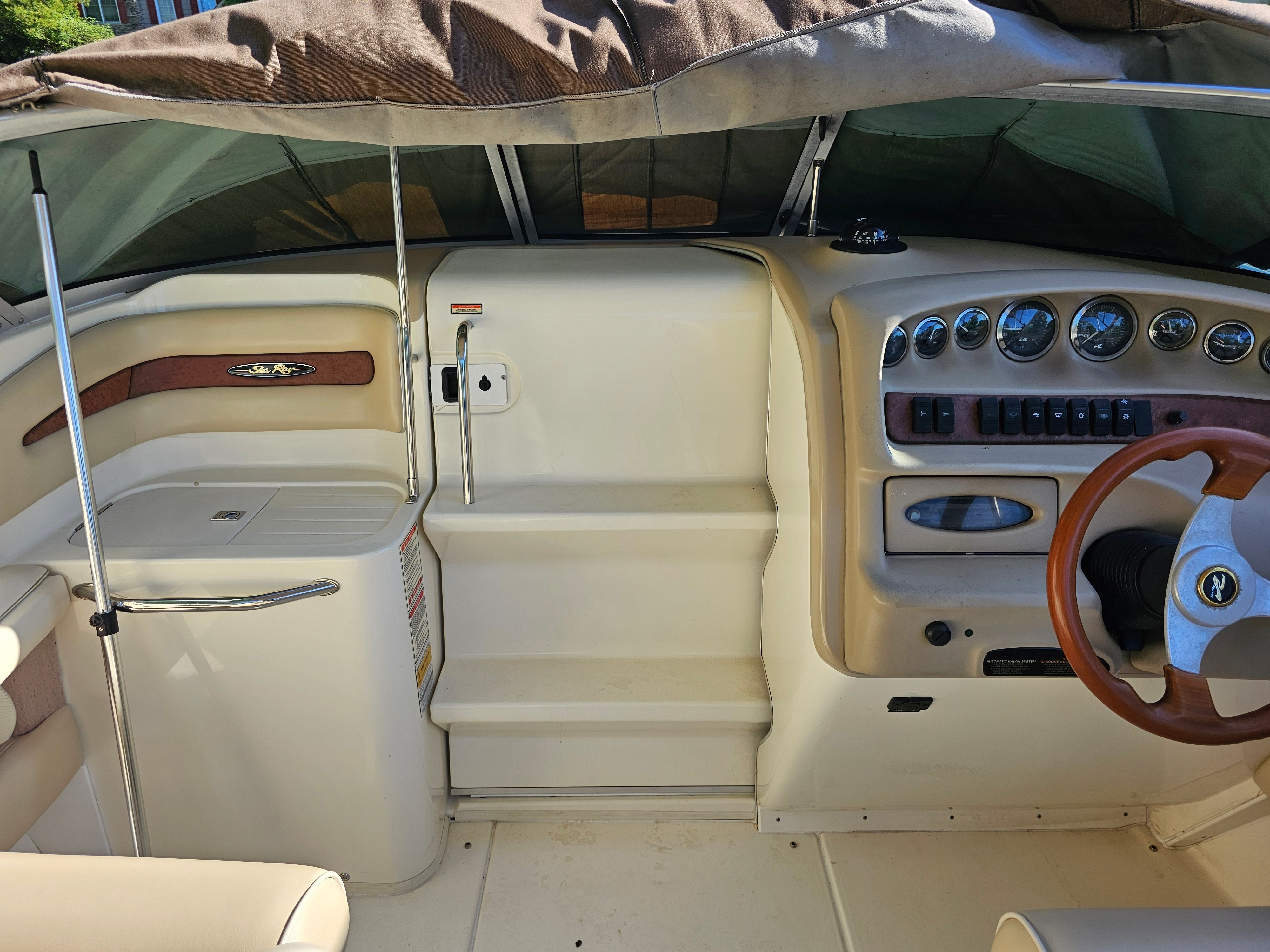 Interior of a 1997 Sea Ray 230 Overnighter with steering wheel and dashboard.