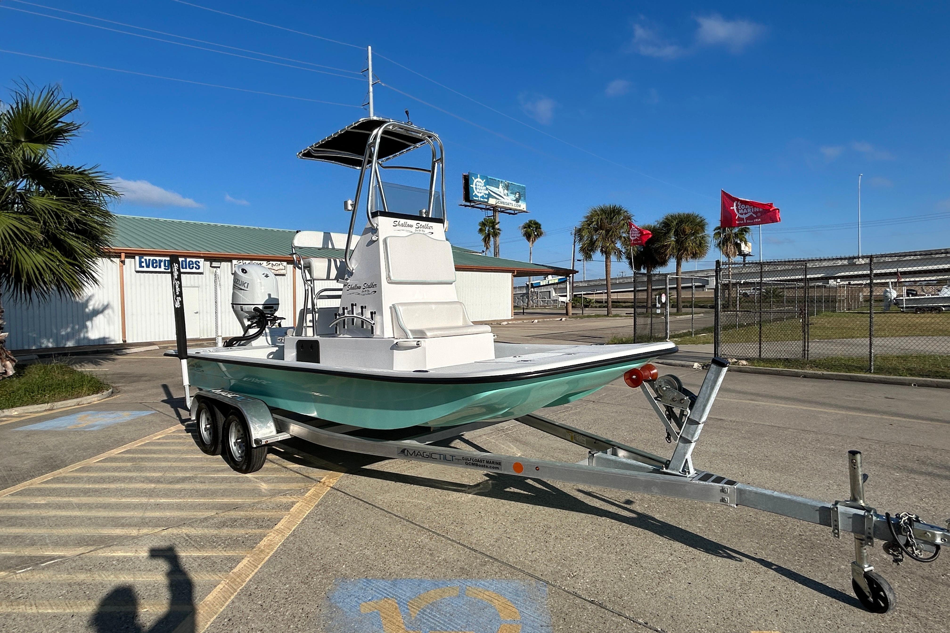 2026 Shallow Stalker CAT 211 PRO boat on trailer, parked outdoors under blue sky.