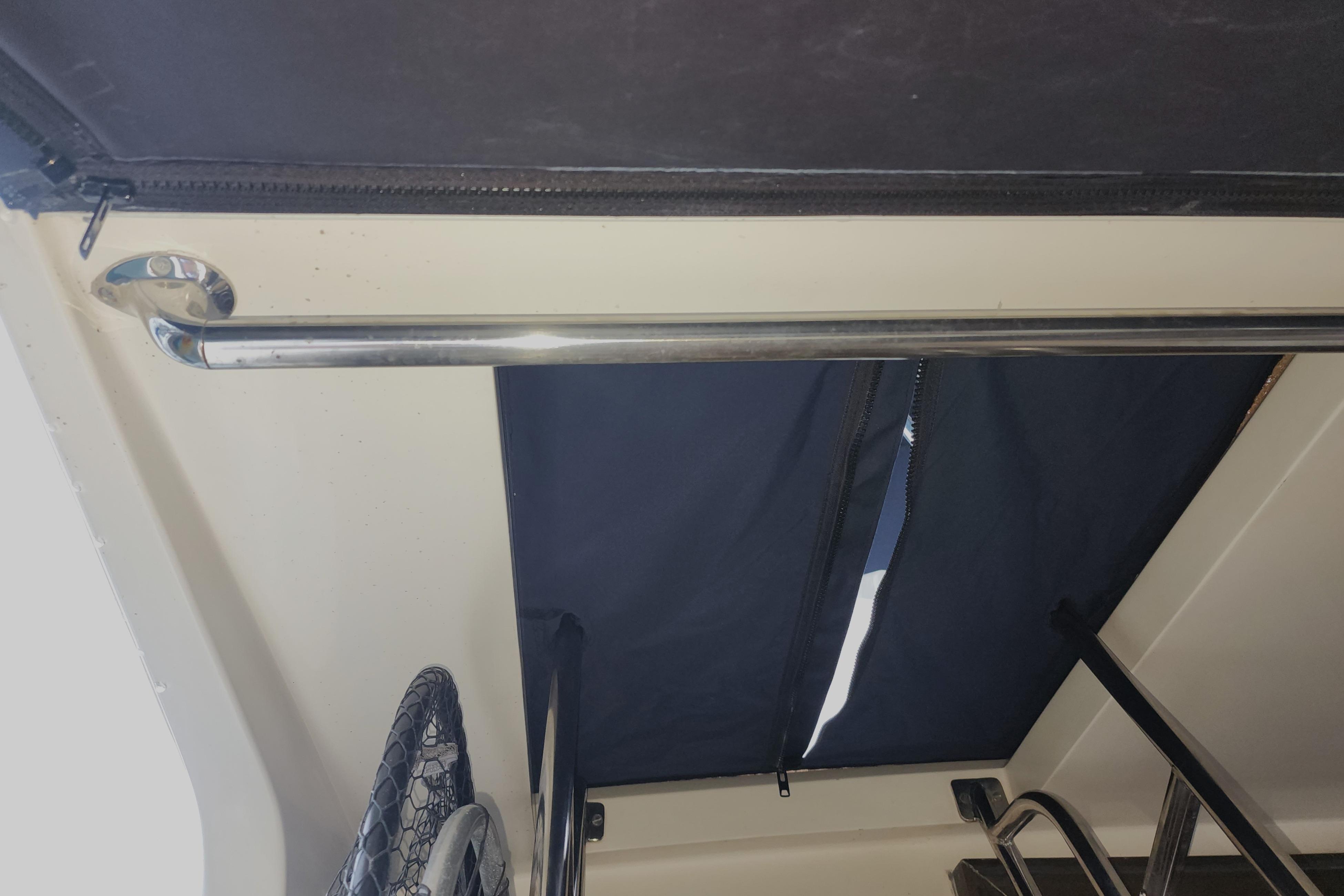 Interior view of a 1991 Roughwater Sportfish boat with metal railing and net.