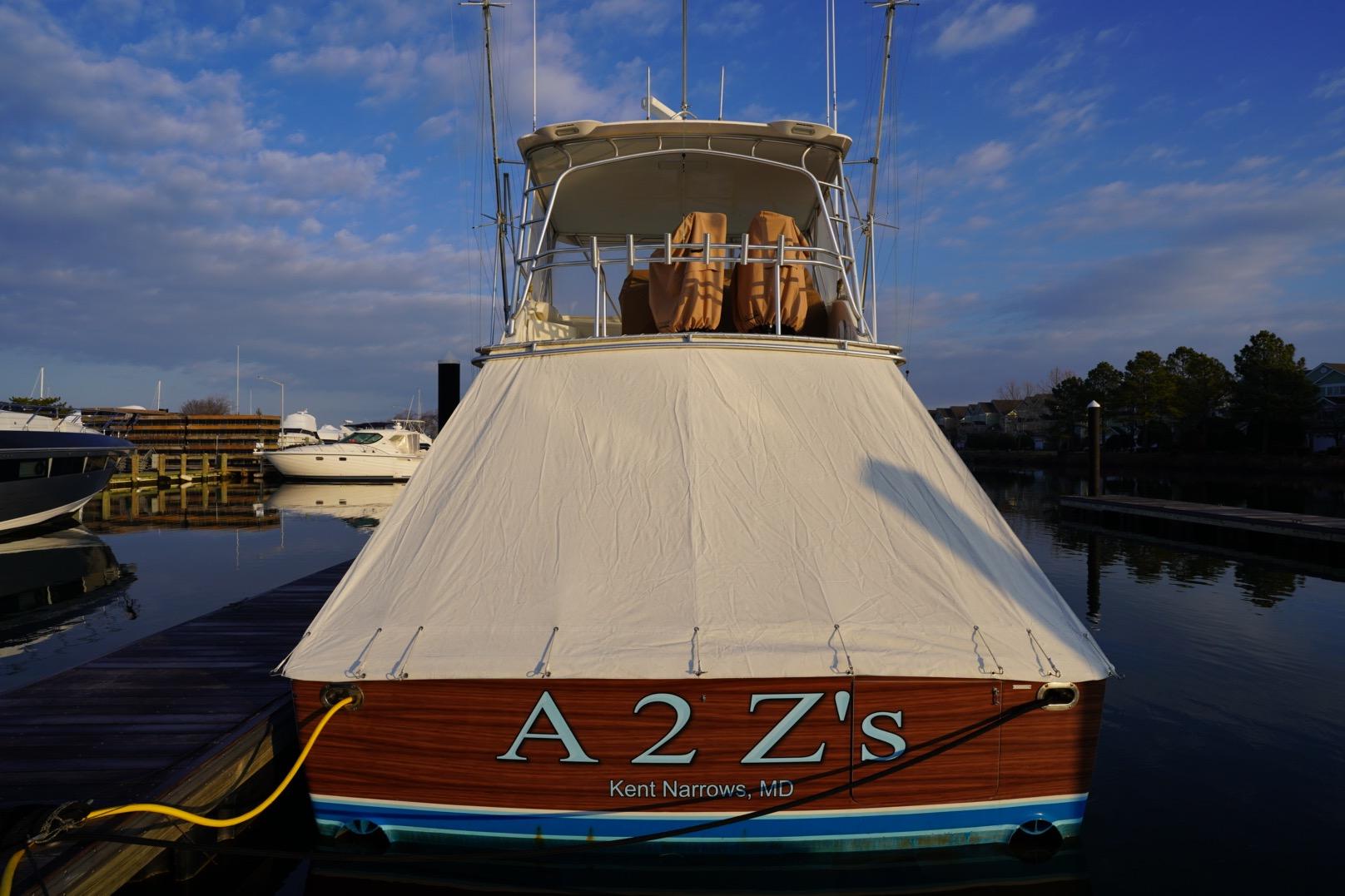 1999 Viking 55 Convertible yacht docked, covered, with "A 2 Z's" name visible, Kent Narrows, MD.