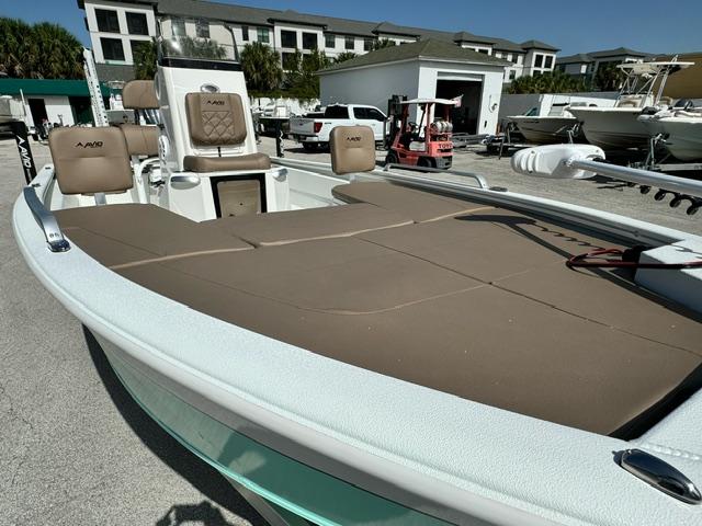 Avid 21 Fusion 2026 boat with brown seating, docked in a marina.