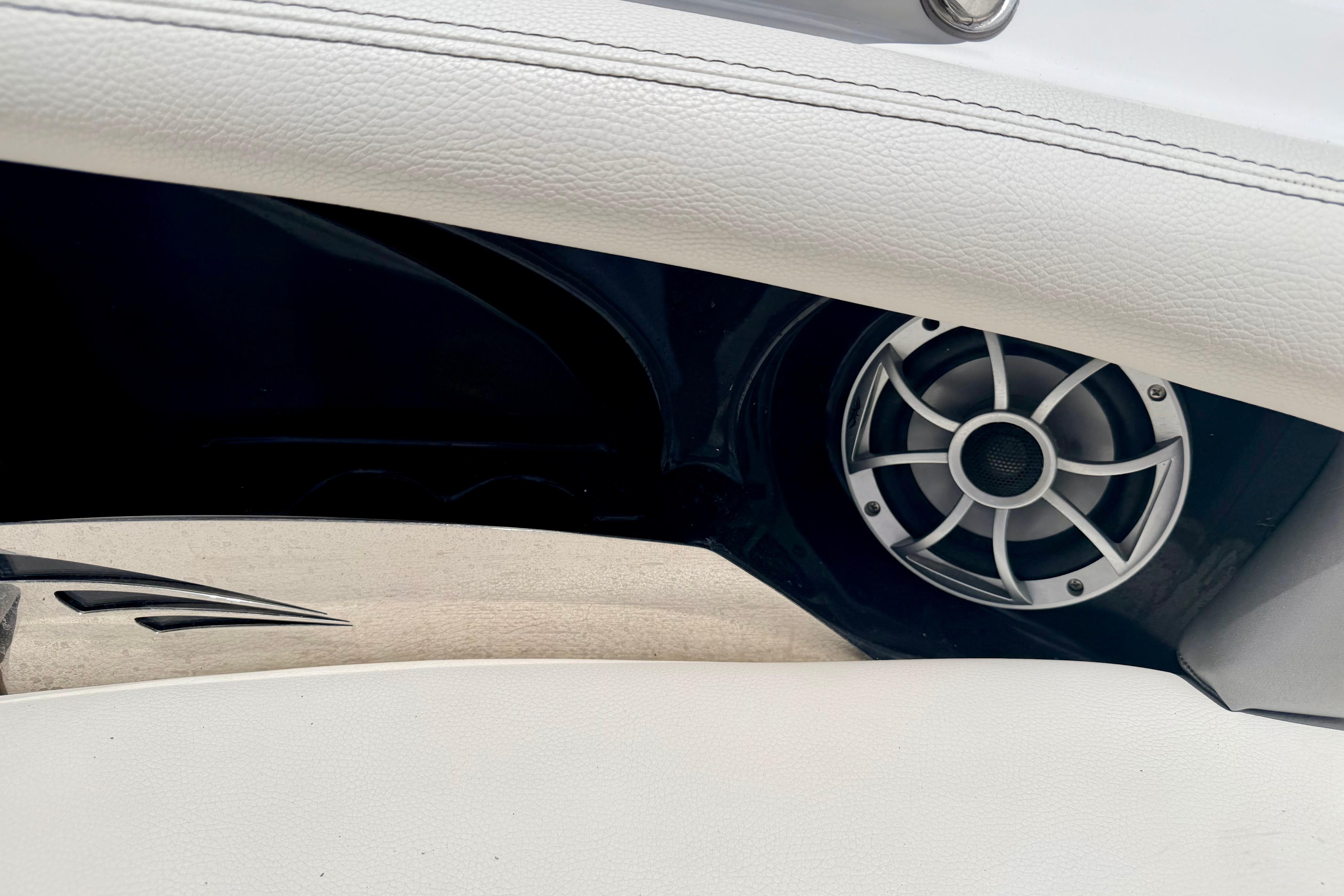Speaker detail in 2014 Tigé R20 boat interior, featuring sleek white upholstery.