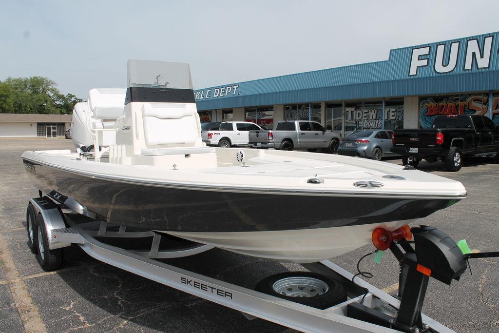 2026 Skeeter SX221 boat on trailer outside dealership, showcasing sleek design and modern features.