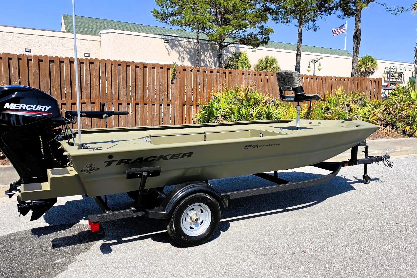 2026 Tracker Grizzly 1654 T Sportsman boat with Mercury engine on trailer.