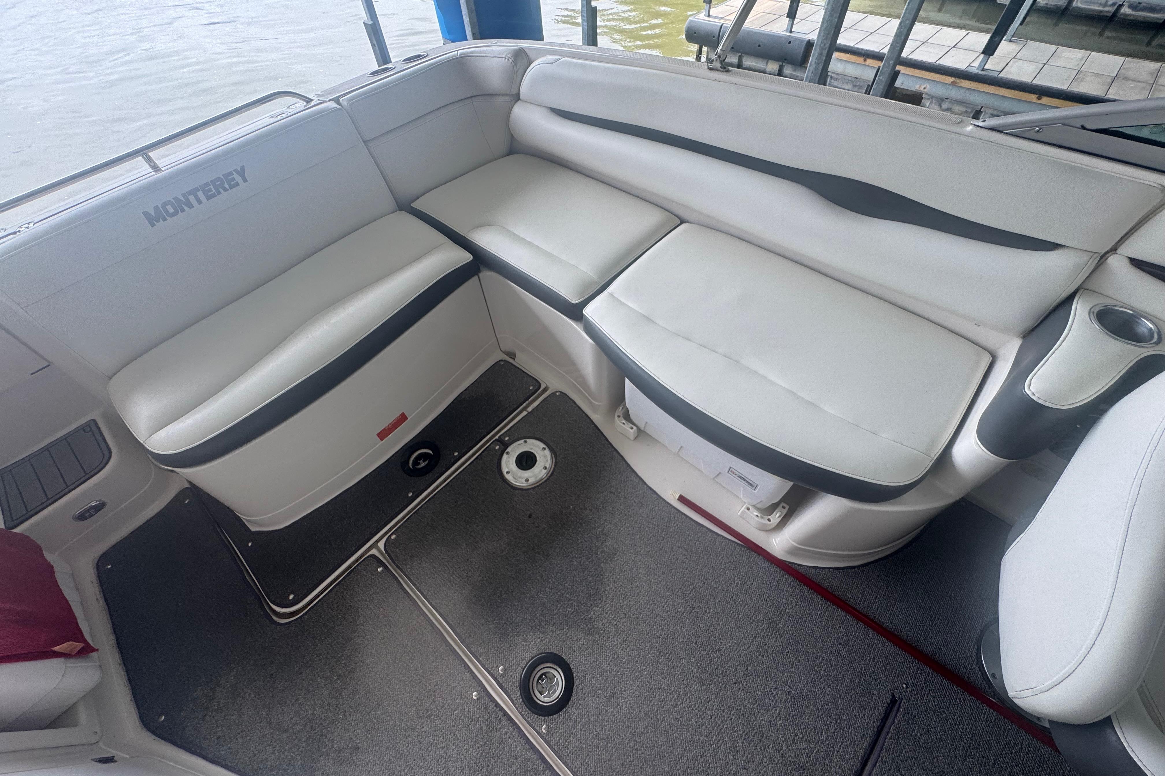 2005 Monterey 248LS Montura Bowrider interior with white seating and cup holders.