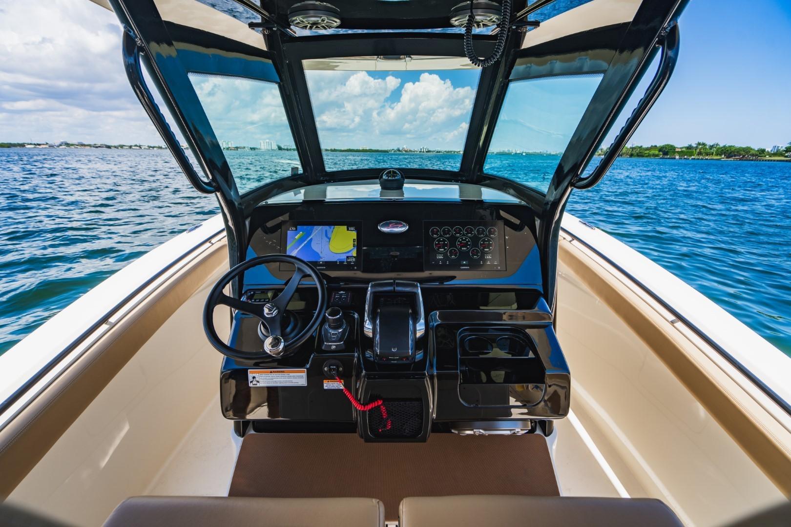 2022 Scout 305 LXF boat cockpit with modern navigation system on open water.