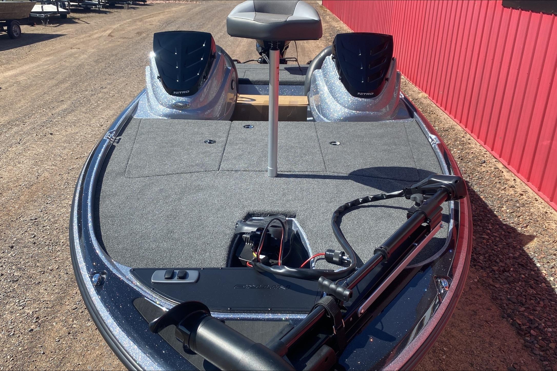 2026 Nitro Z17 fishing boat with dual seats and trolling motor, parked on gravel.