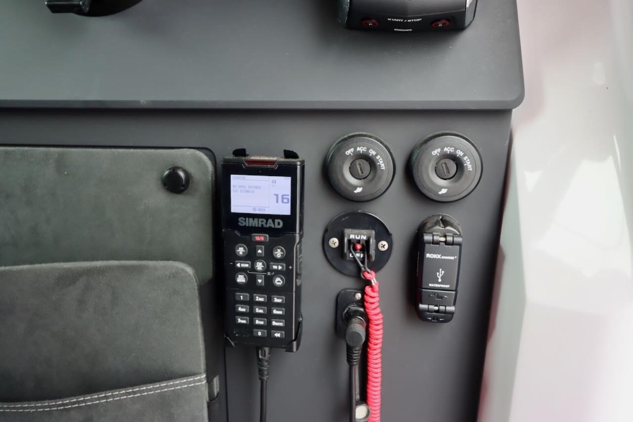Control panel of 2022 Axopar 37 XC Cross Cabin with Simrad radio and USB charger.