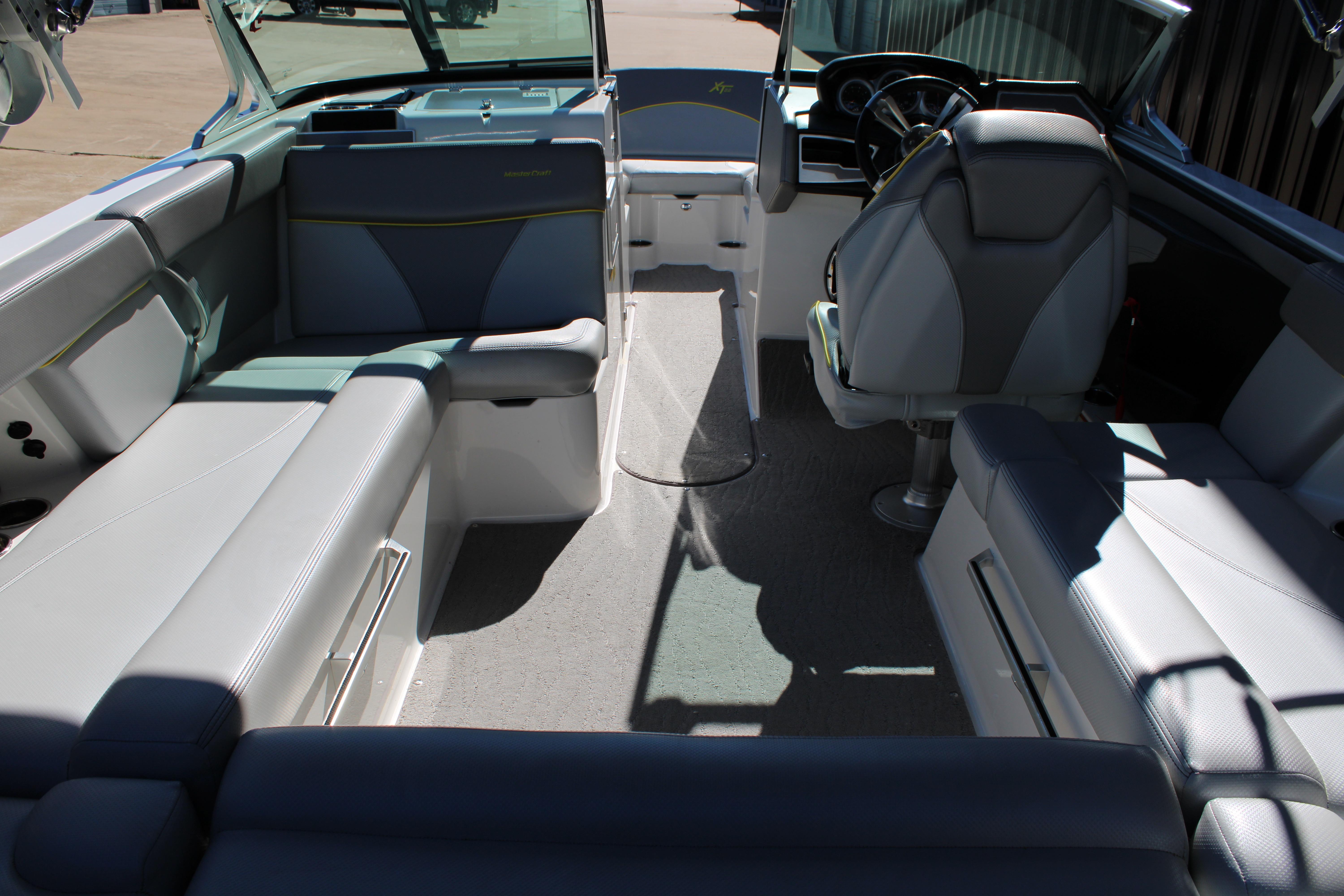 Interior of a 2018 MasterCraft XT22 boat with seating and steering area.