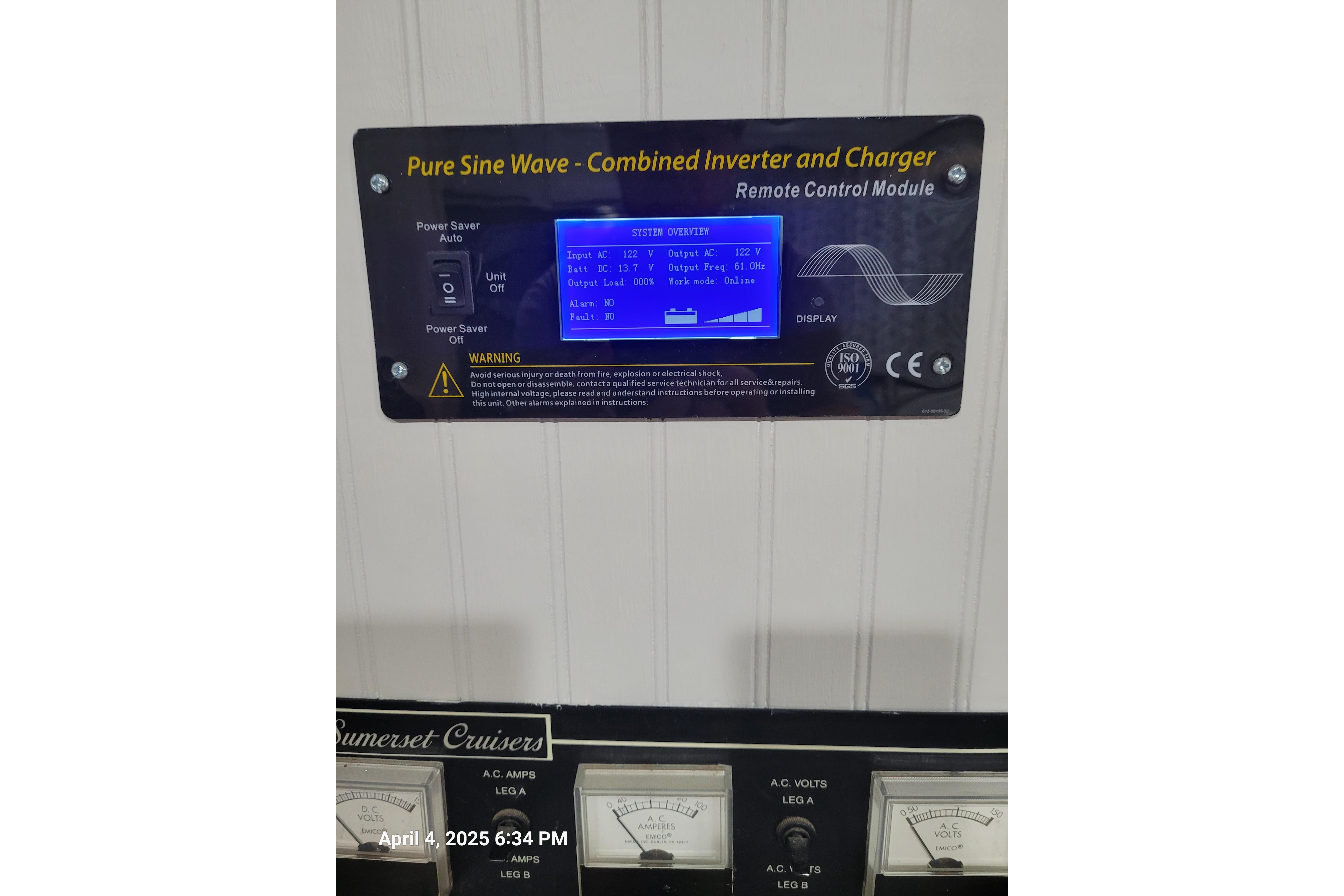 Control panel of a 1990 Sumerset 16 x 70 houseboat with inverter and charger display.