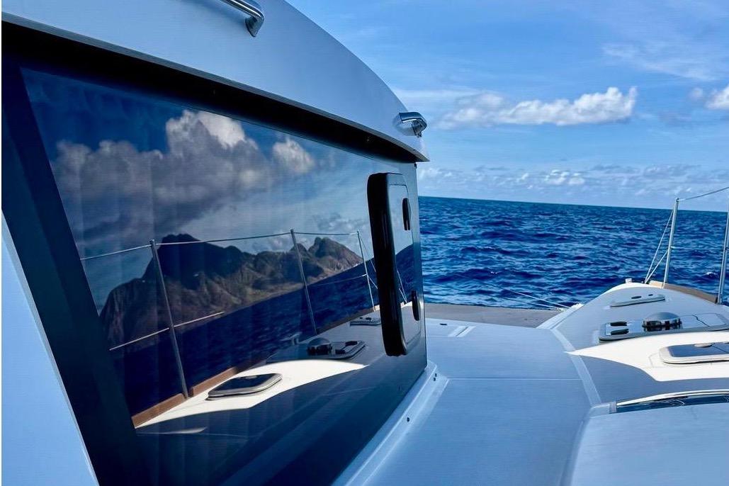 NEEL 47 trimaran sailing on open sea under clear blue sky, 2020 model.