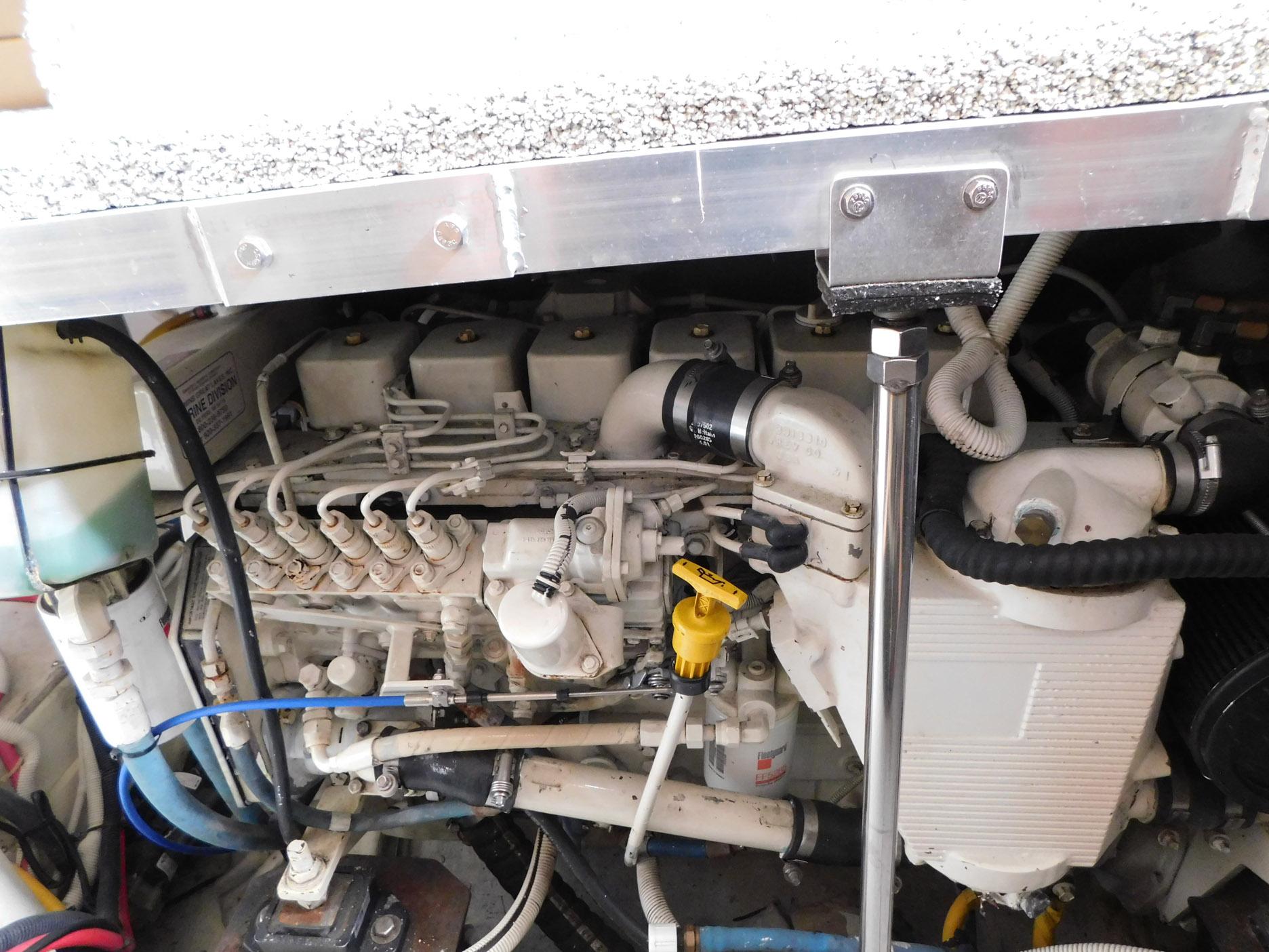 Engine compartment of a 2003 Carver 444 Cockpit Motor Yacht, showcasing mechanical components.