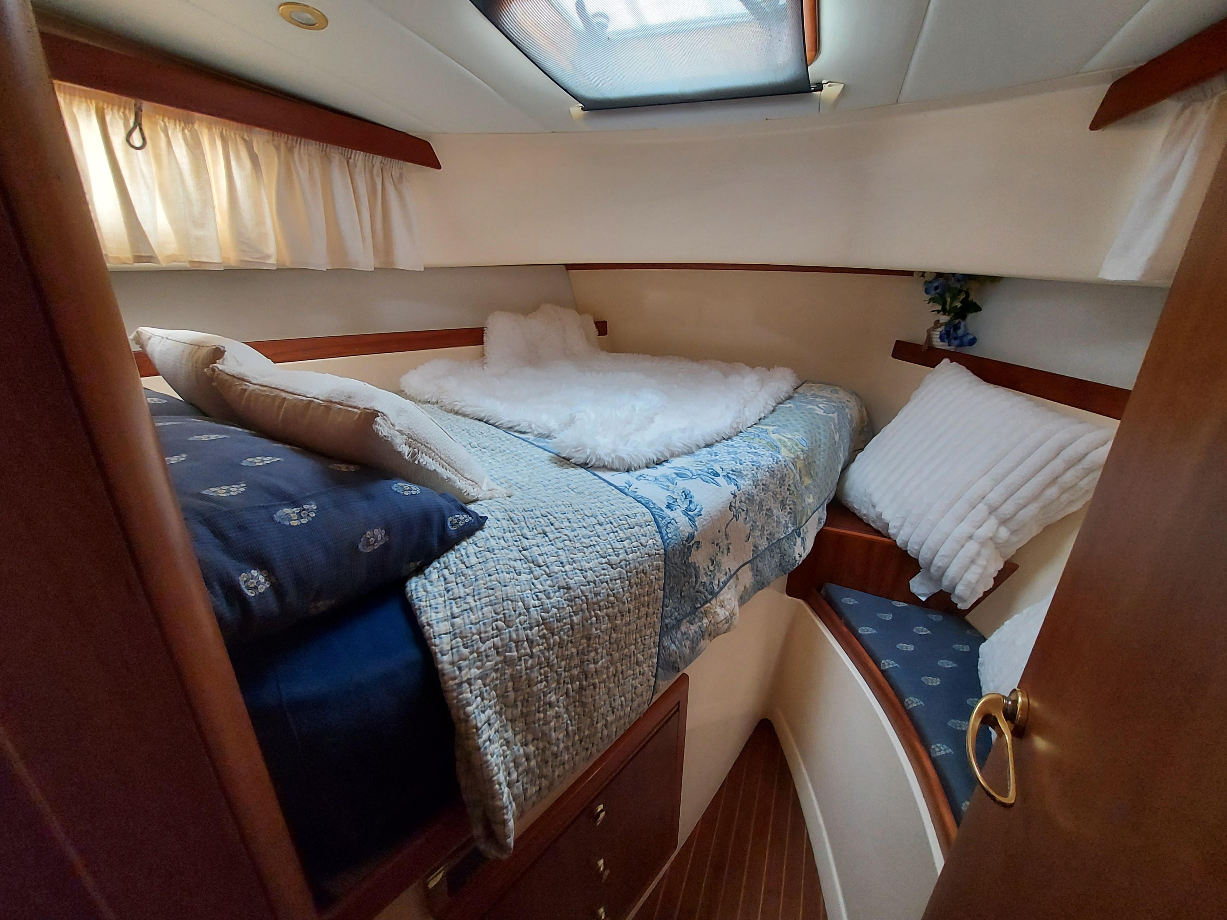 Cozy cabin interior of 2001 Apreamare 10M CABINATO with comfortable bedding and natural light.