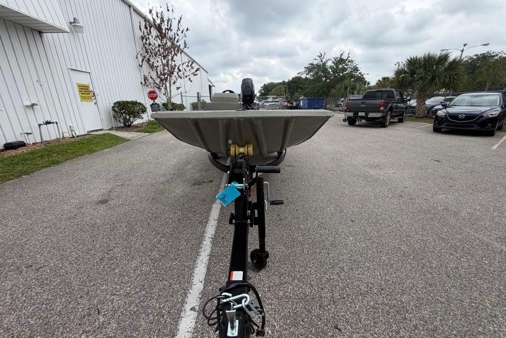 2026 Tracker Grizzly 1648 SC boat on trailer in parking lot.