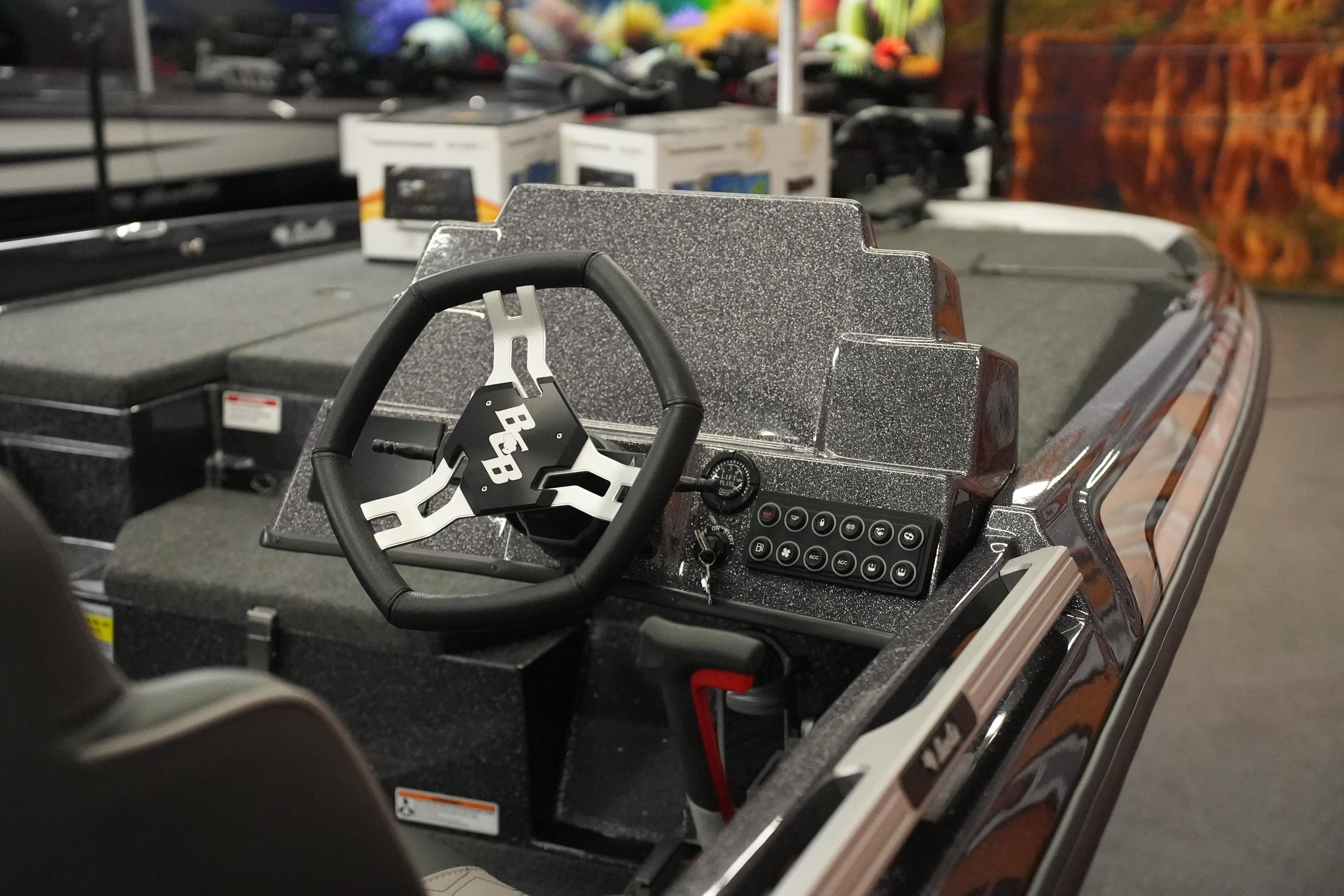 2026 Bass Cat Puma STS boat interior with steering wheel and control panel.