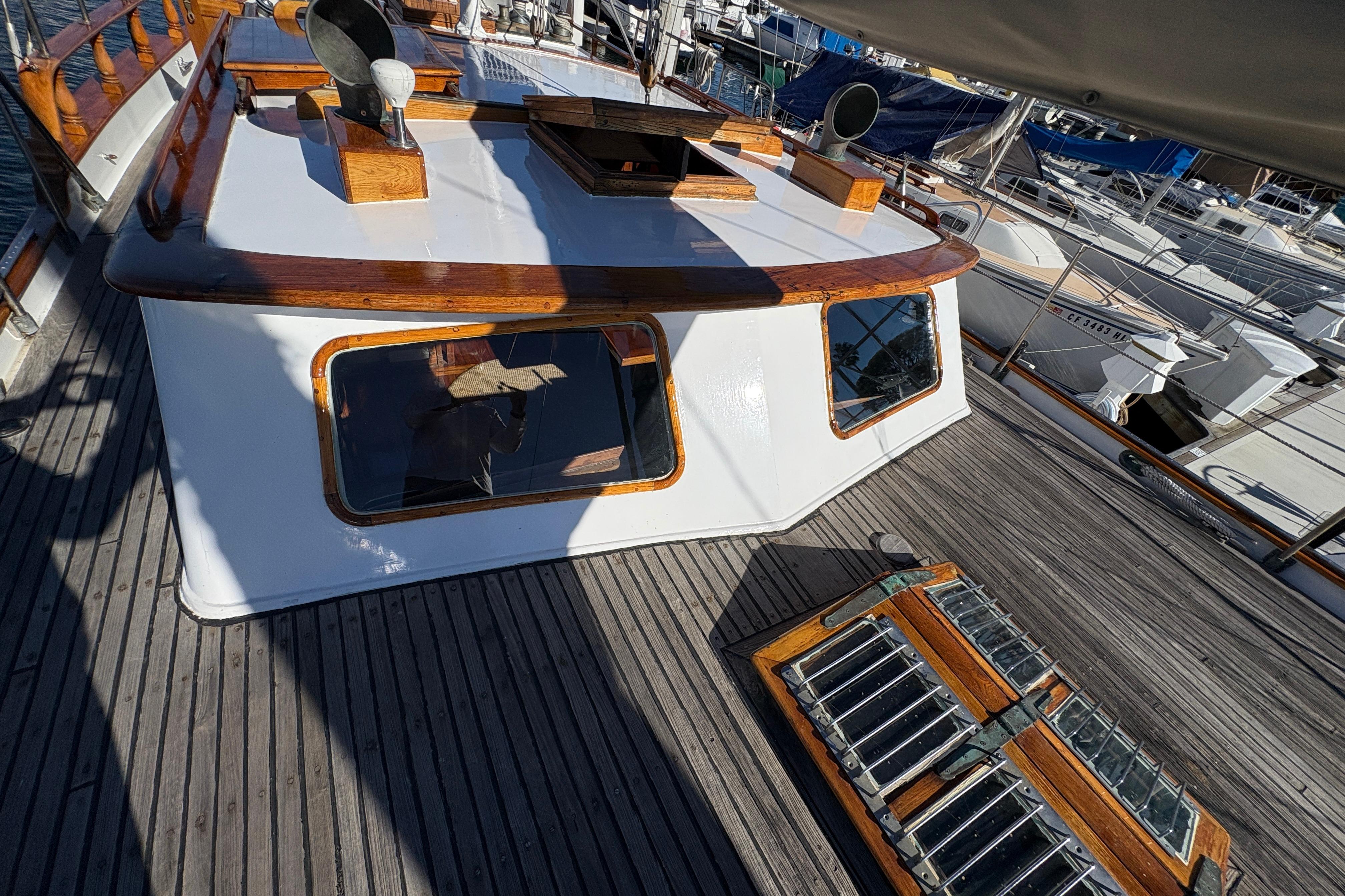 1979 Formosa 51 yacht deck with wooden accents and windows in a marina.