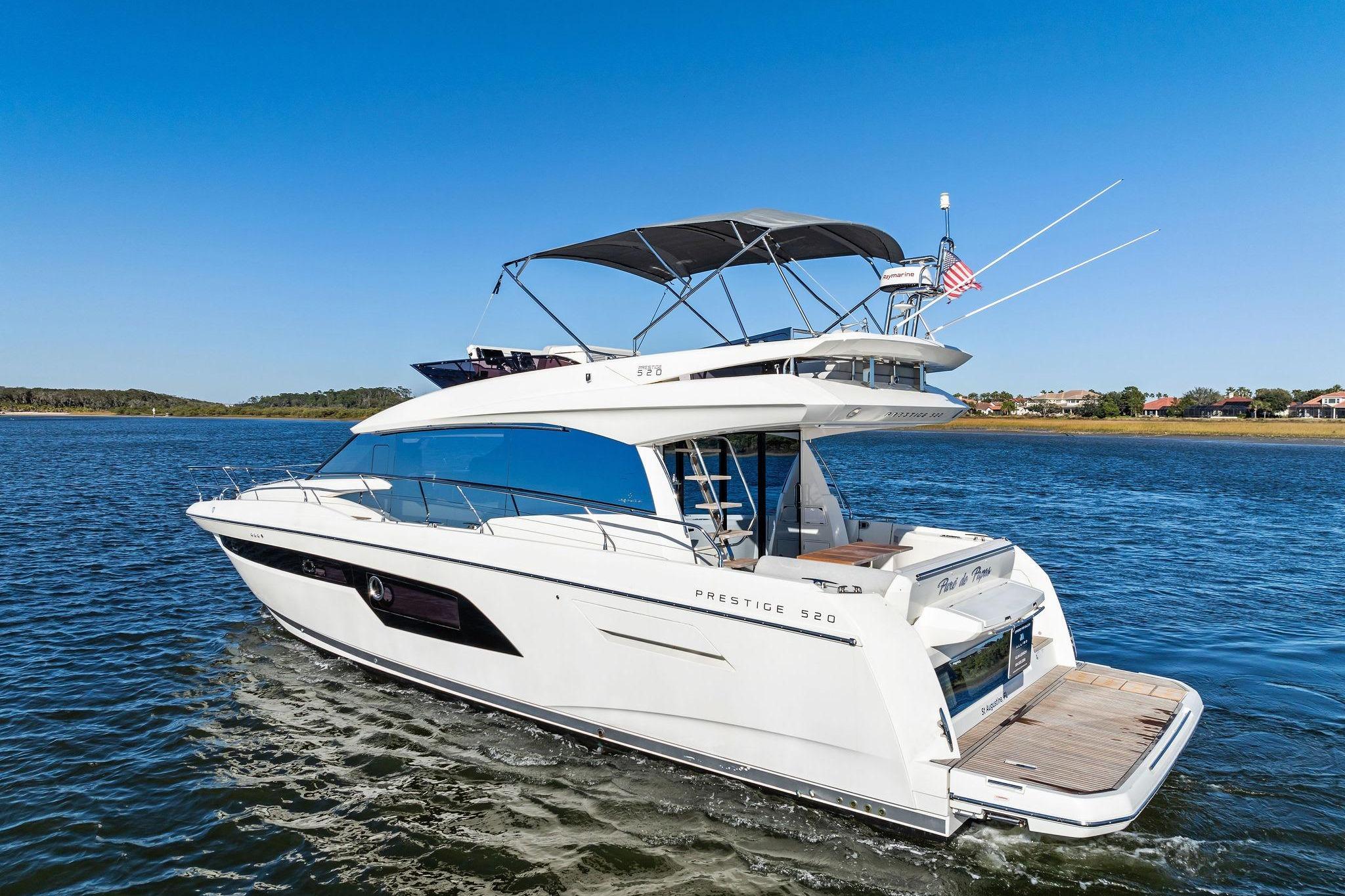2019 Prestige 520 yacht cruising on a sunny day, showcasing sleek design and luxury features.
