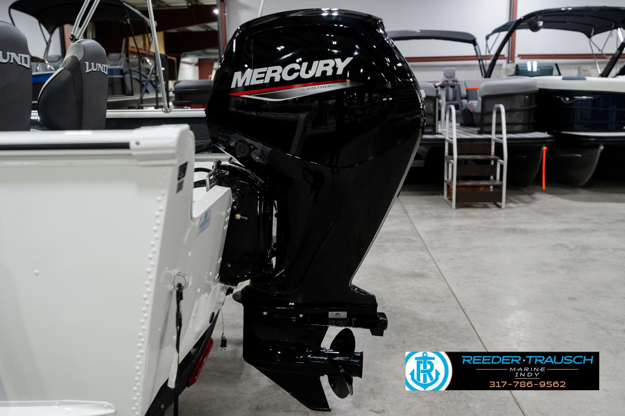 2026 Lund 1700 Explorer Sport boat with Mercury outboard motor in showroom.