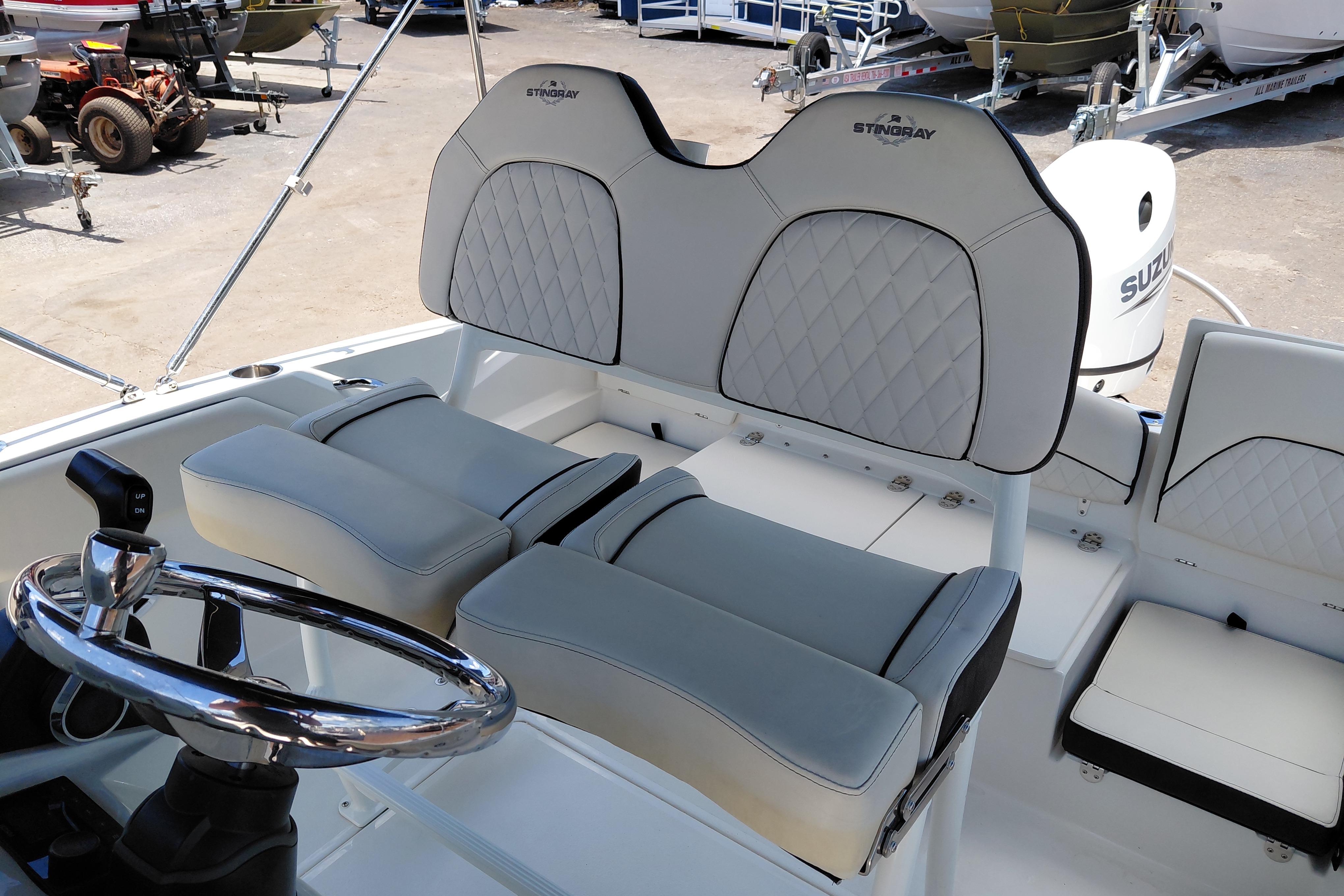 2023 Stingray 206 CC boat interior with plush seating and steering wheel.