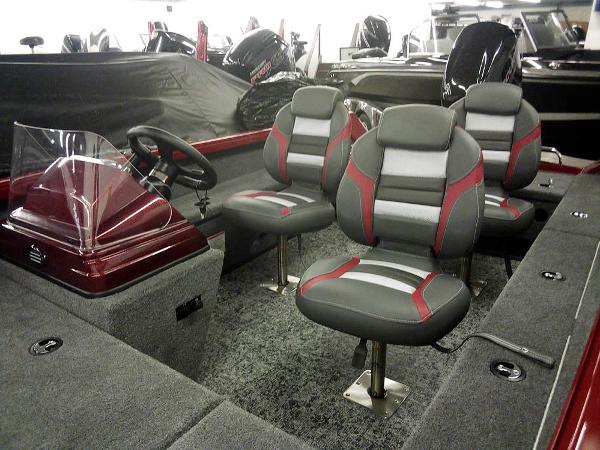 2025 Ranger VS1665 SC boat interior with gray and red seating, steering console, and carpeted flooring.