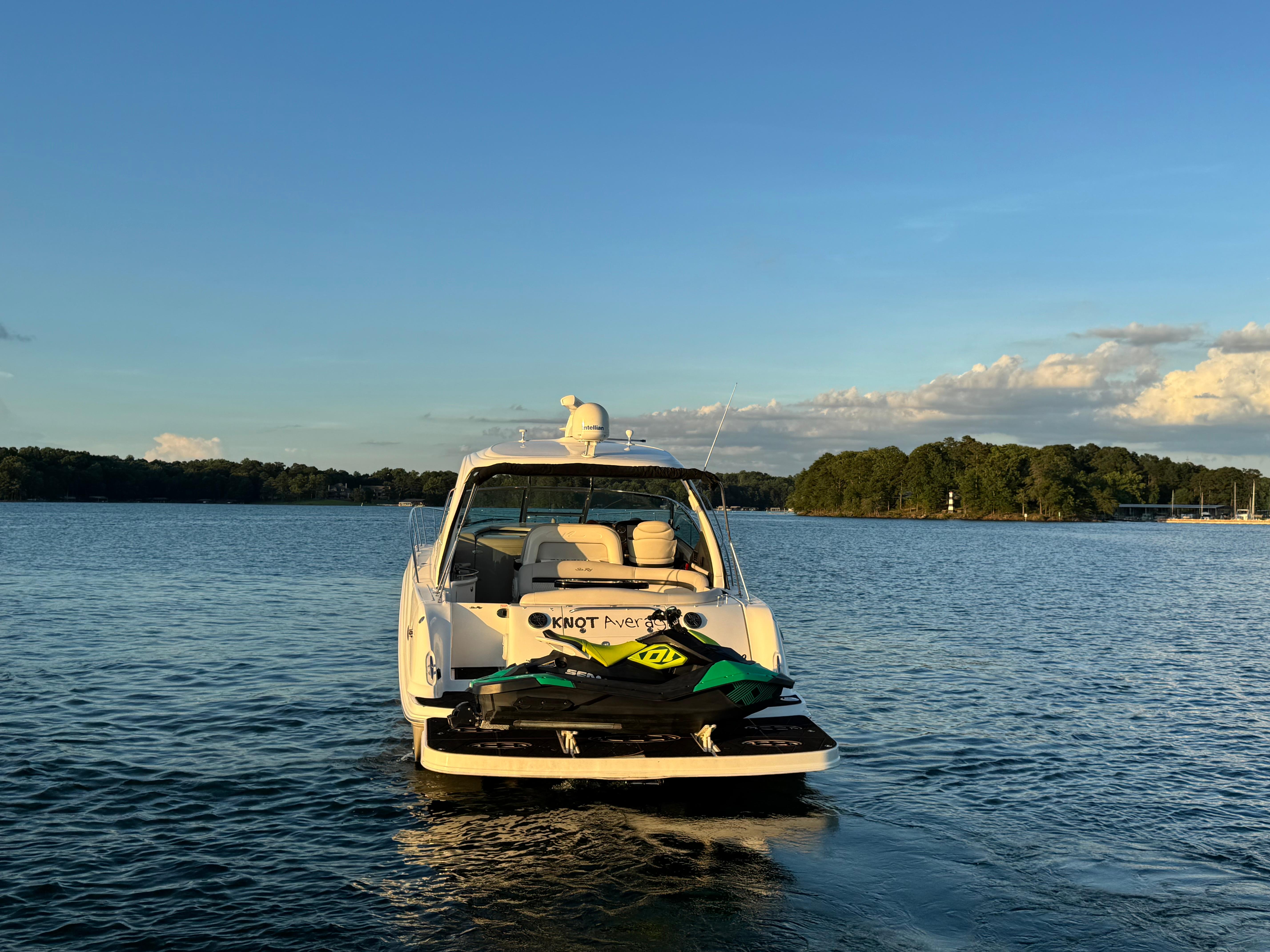 2005 Sea Ray 420 Sundancer yacht on calm water at sunset.