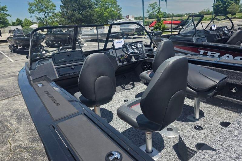 2026 Tracker Targa V-18 Combo boat interior with seating and dashboard in a parking lot.