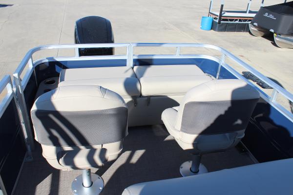 2025 Sun Tracker Fishin' Barge 22 DLX interior with seating and railing.