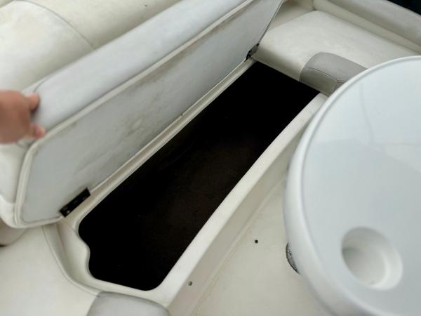 Open storage compartment on 2006 Larson LXi 248 boat interior.