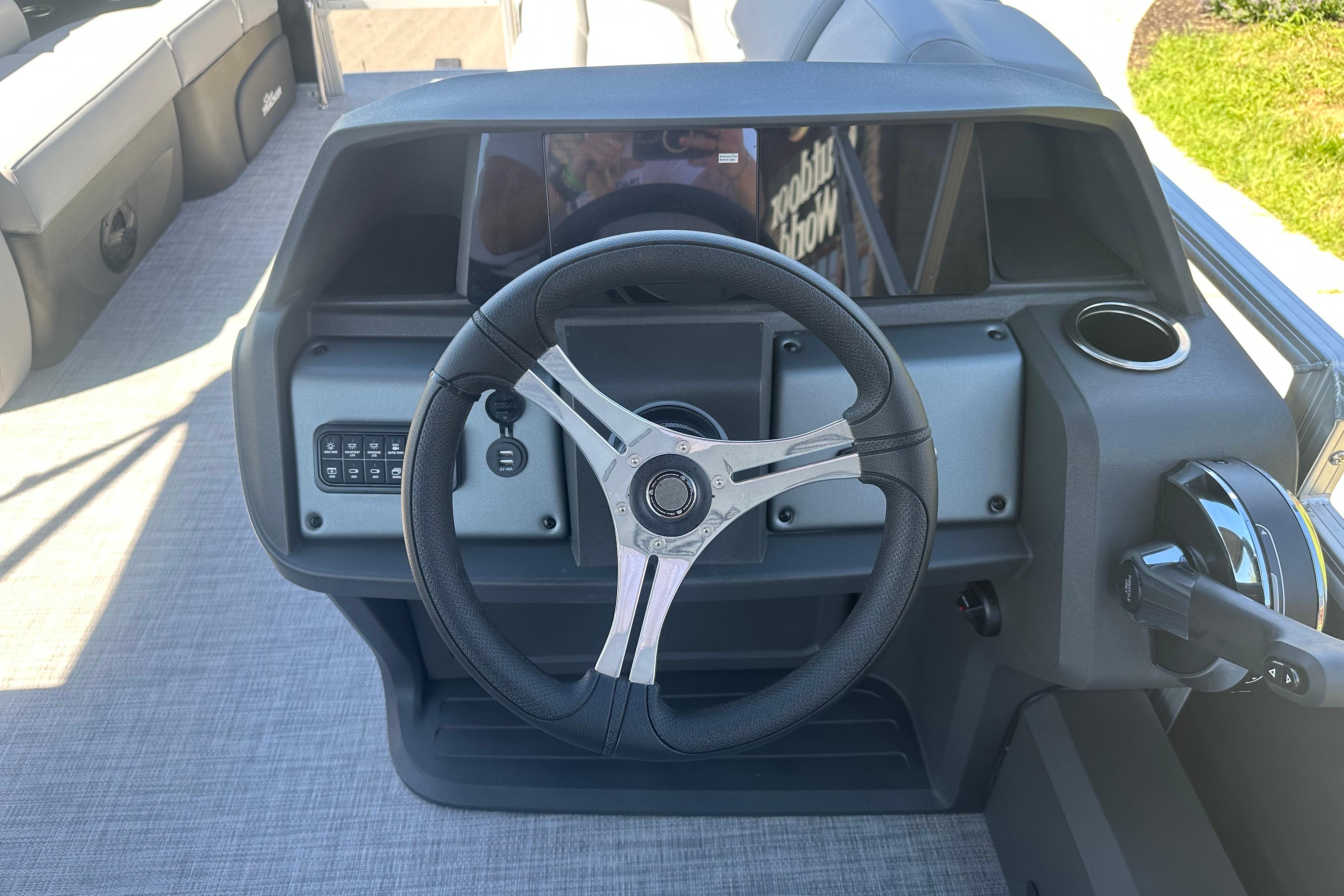 2026 Sun Tracker SportFish 22 DLX steering console with modern controls and sleek design.