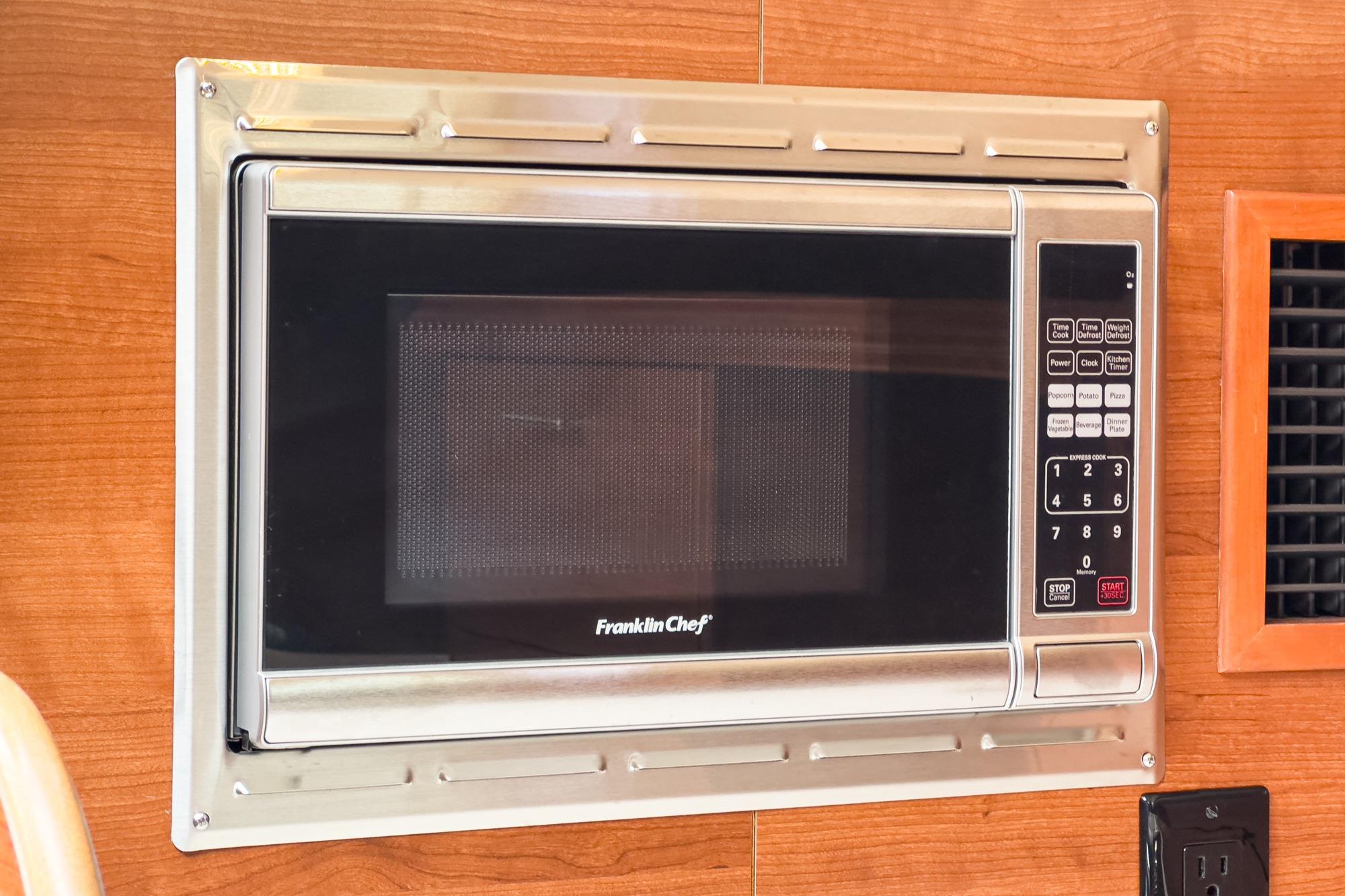 Built-in Franklin Chef microwave in a 2015 Hunter 33, mounted on wood paneling.