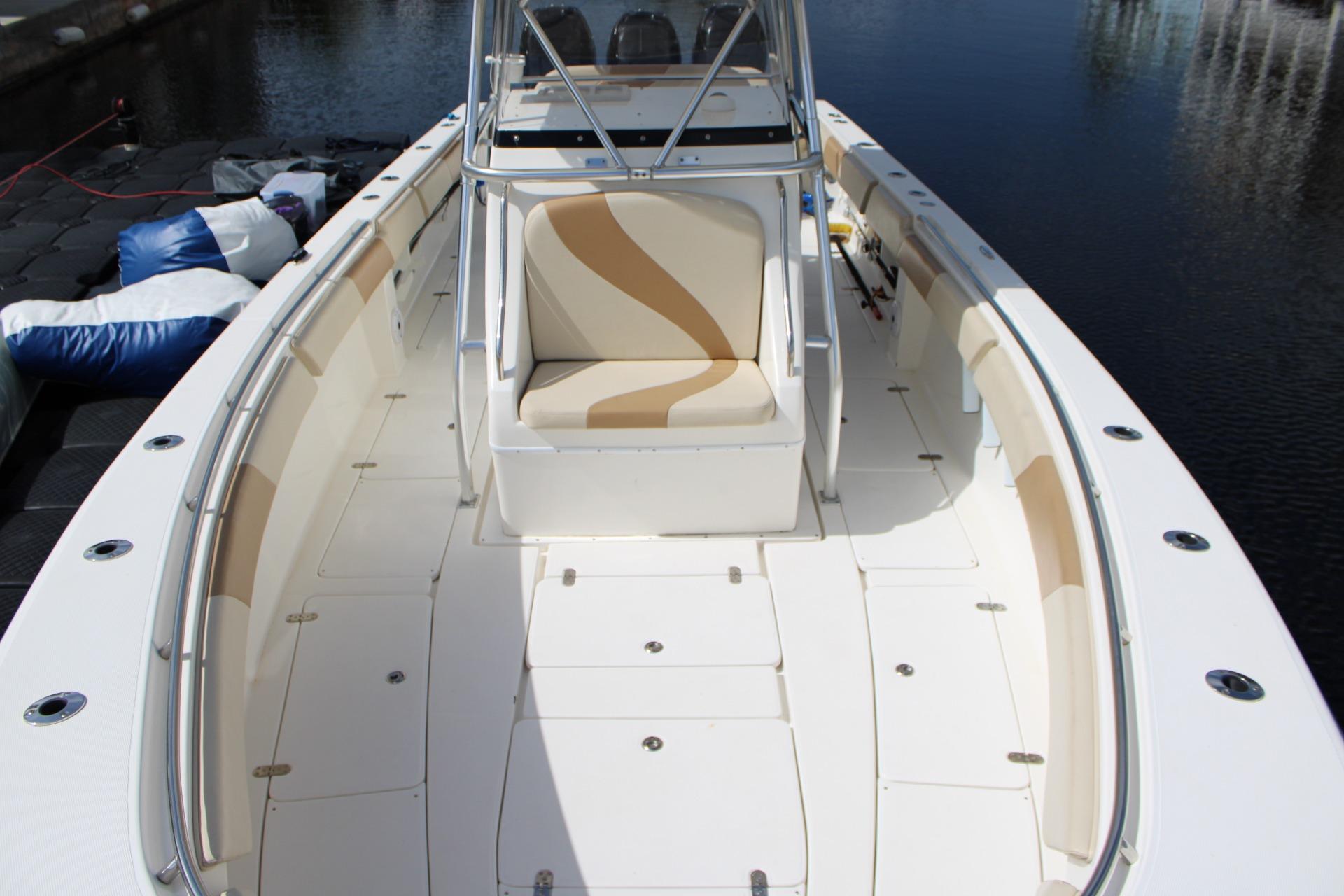 2007 Fountain 34 Center Console boat with spacious deck and seating, docked by the water.
