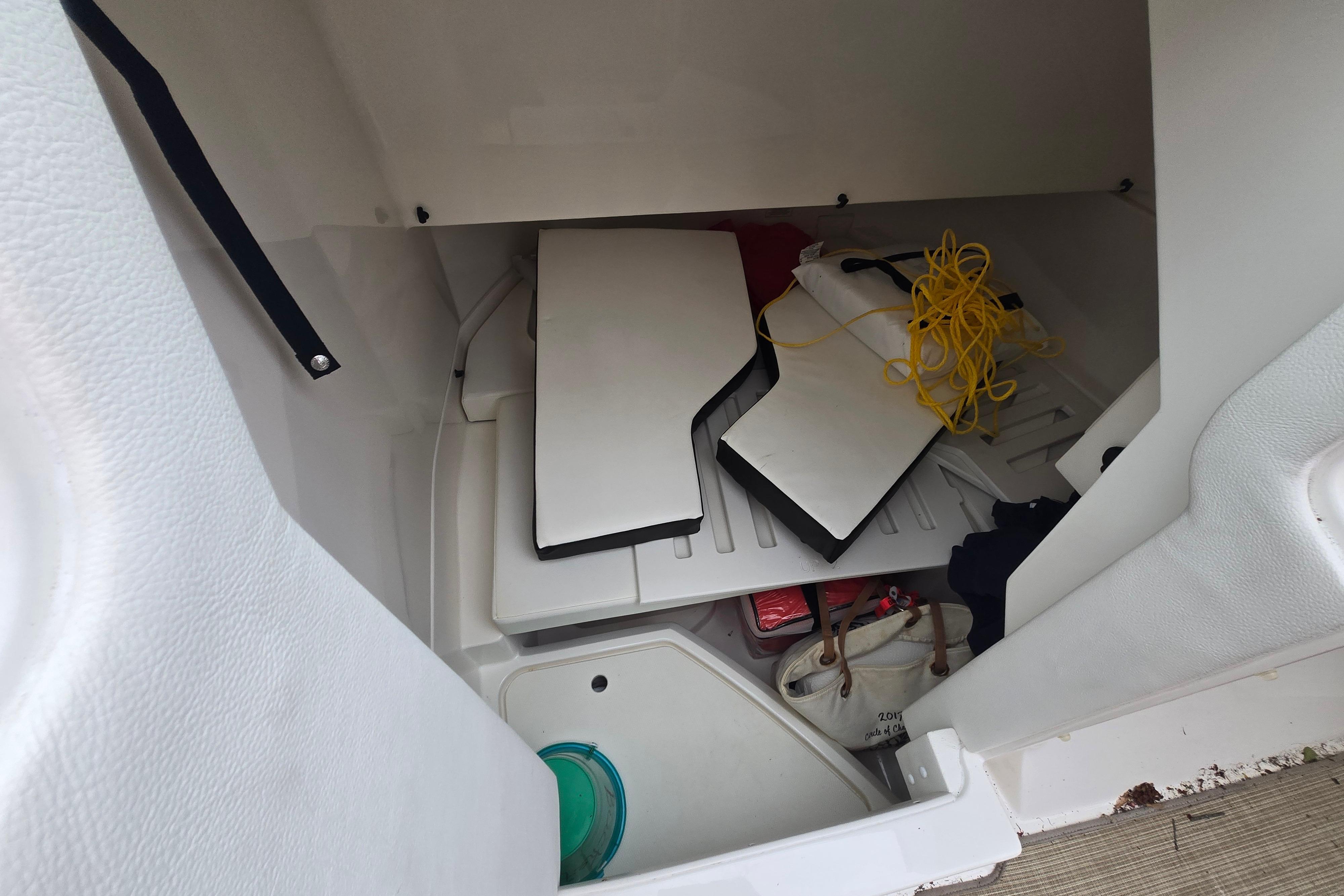 Storage compartment of 2018 Sea Ray SDX 250 boat with equipment and accessories.