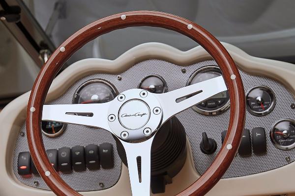 Manufacturer Provided Image: 2016 Chris-Craft Carina 21 dashboard with wooden steering wheel and gauges.