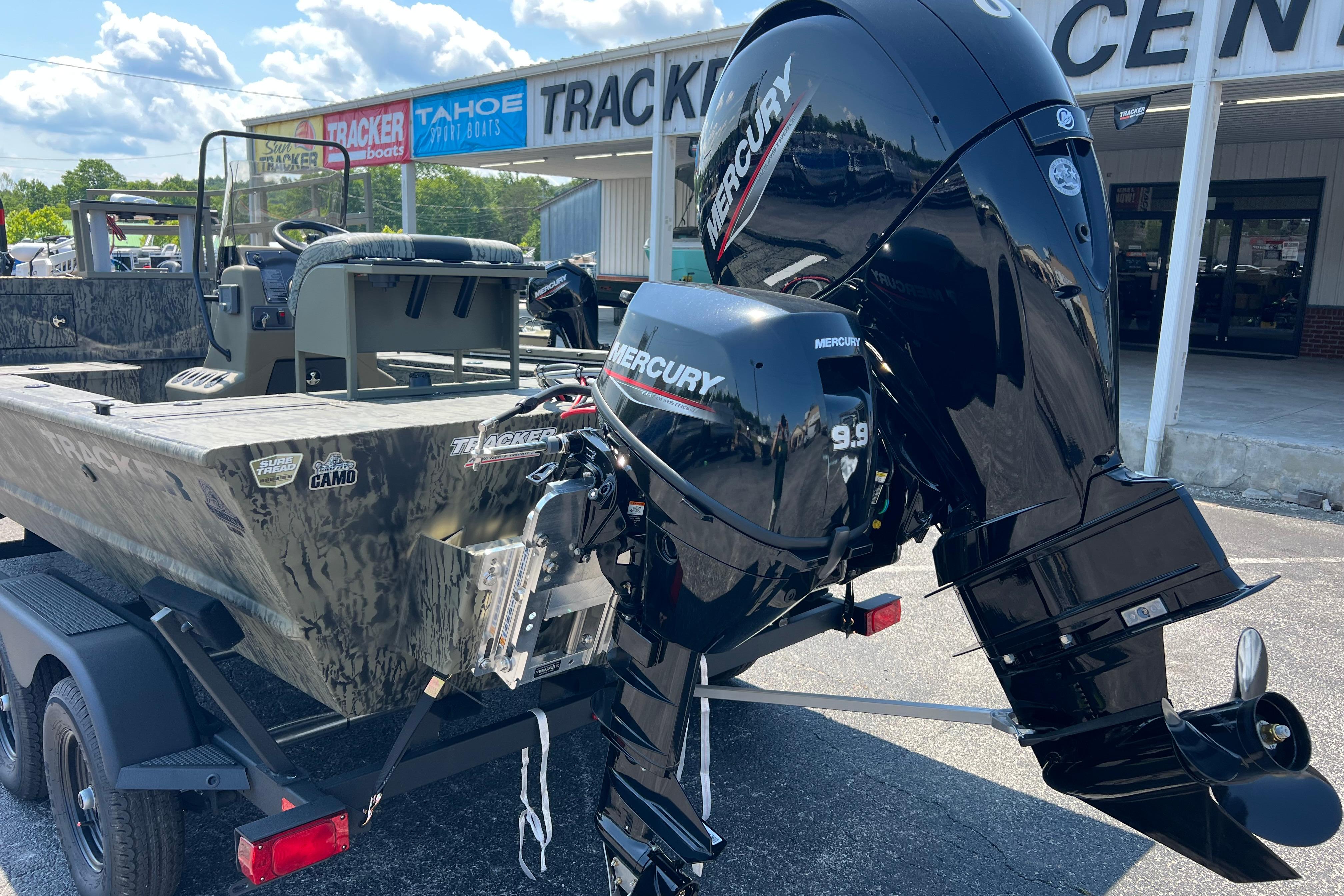 2026 Tracker Grizzly 2072 CC Sportsman Kicker boat with Mercury engines at dealership.