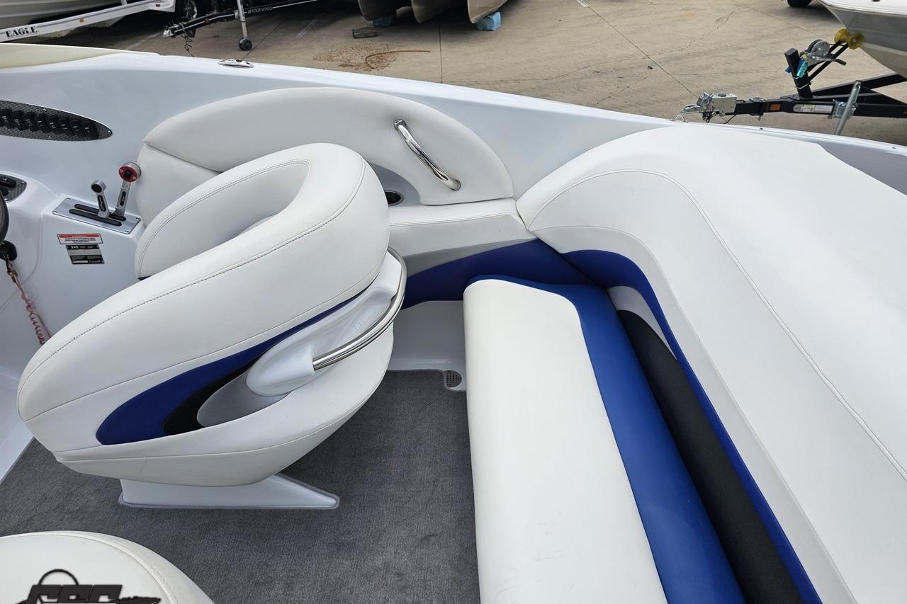 2004 Baja H2X boat interior with white and blue seating, showcasing sleek design.