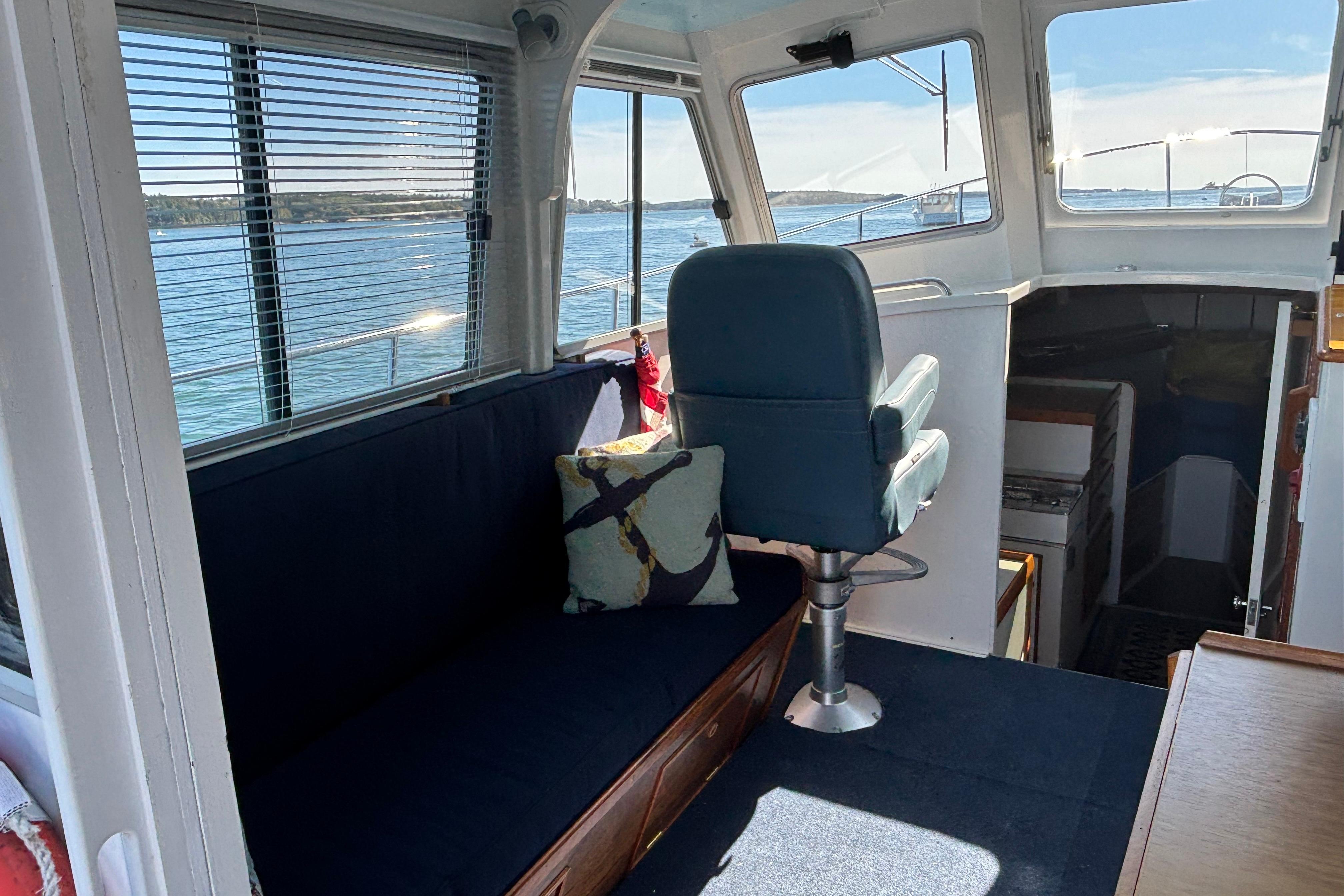 Interior of 1985 Jarvis Newman 36 boat with seating and ocean view.