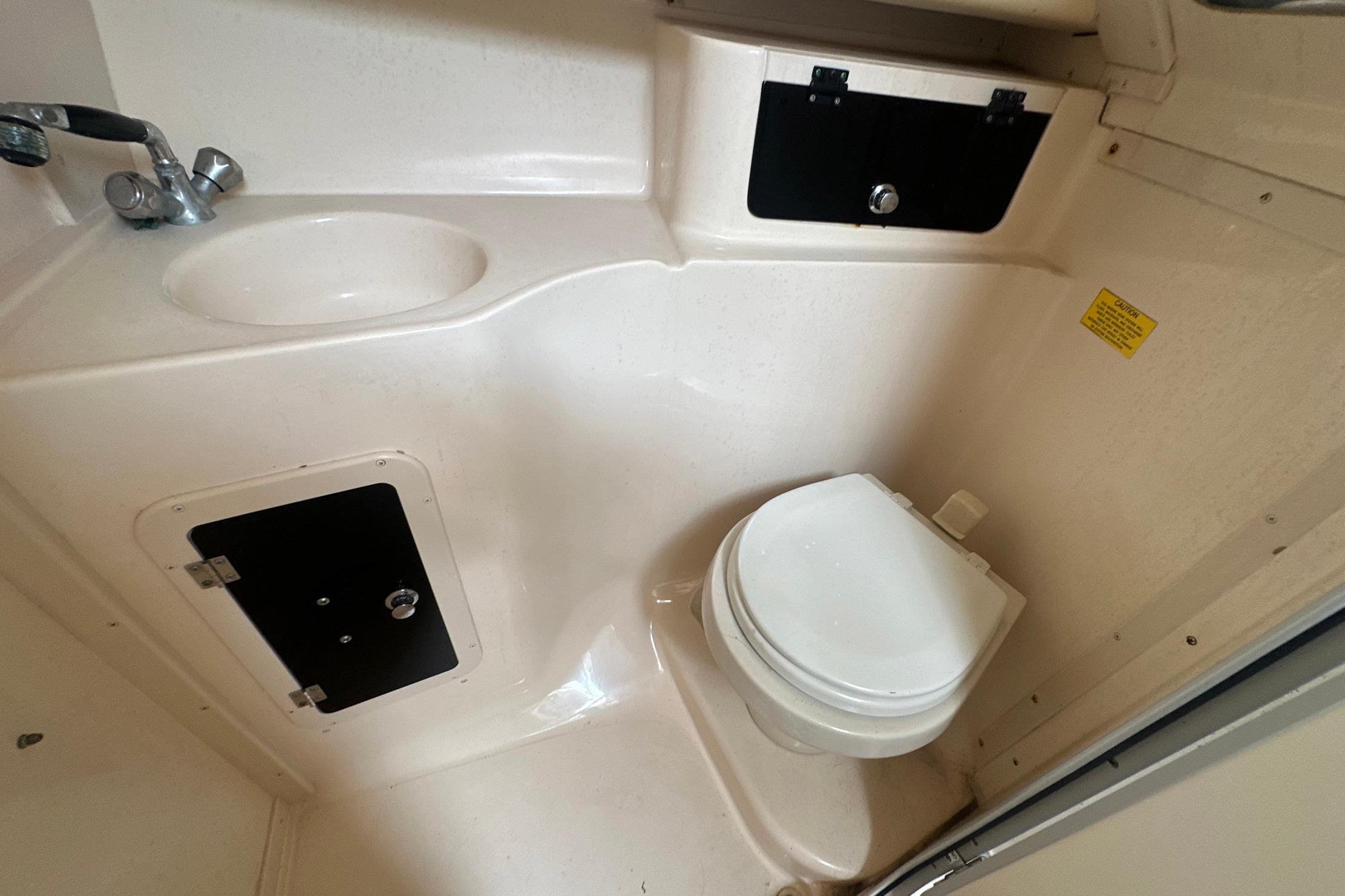 2006 Grady-White Marlin 300 boat bathroom with sink and toilet.