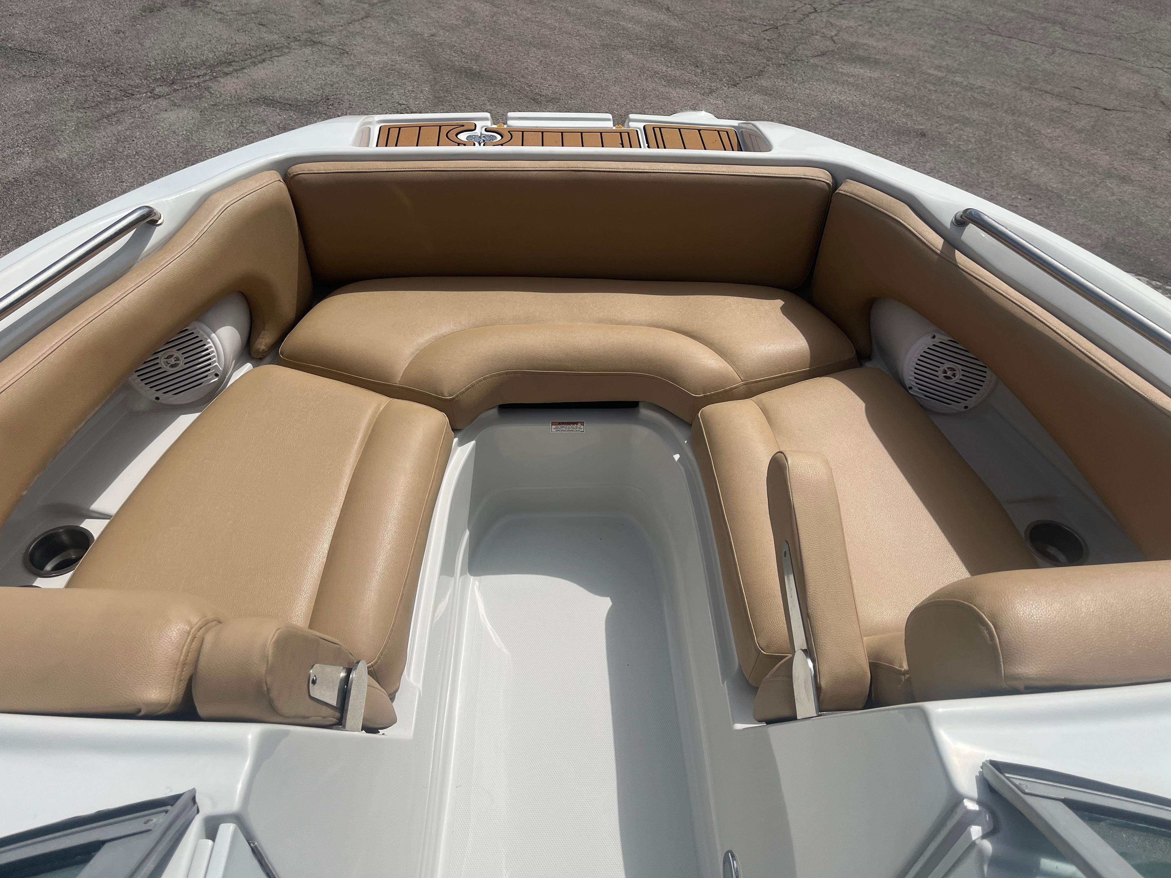 2022 Crownline Eclipse E235 XS boat interior with tan seating and cup holders.